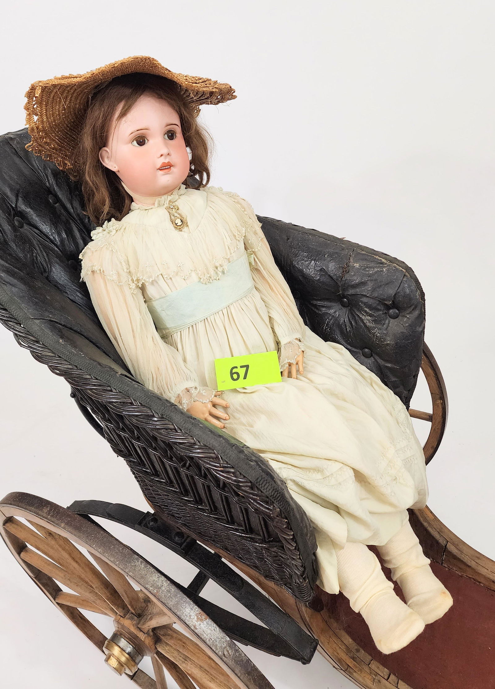 40" S.F.B.J. FRENCH BISQUE-HEAD DOLL: Bisque head and composition body, open mouth with teeth, brunette, pierced ears, white silk gown with embroidered fleur de lis, lace ruffles, and blue silk sash and in straw hat. 40" high.