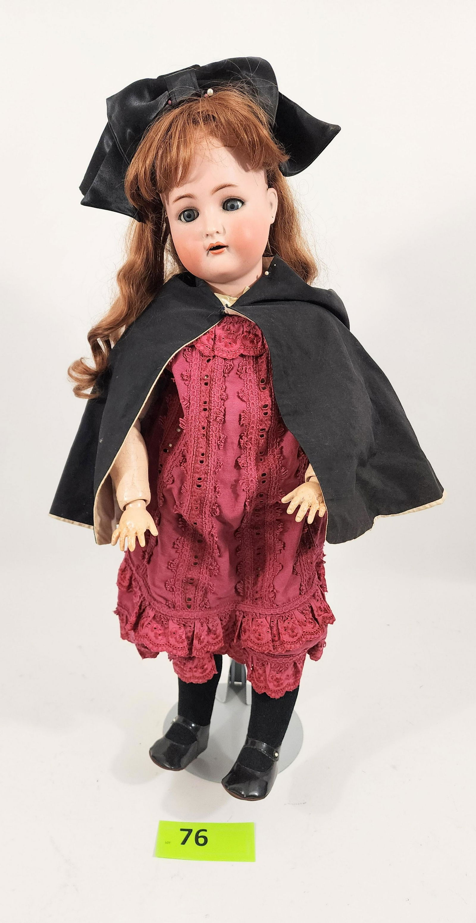31" SIMON-HALBIG SLEEPY-EYE DOLL: Bisque head and composition body, open mouth with teeth, pierced ears, auburn hair. In mostly modern outfit with black cape. 30" high.