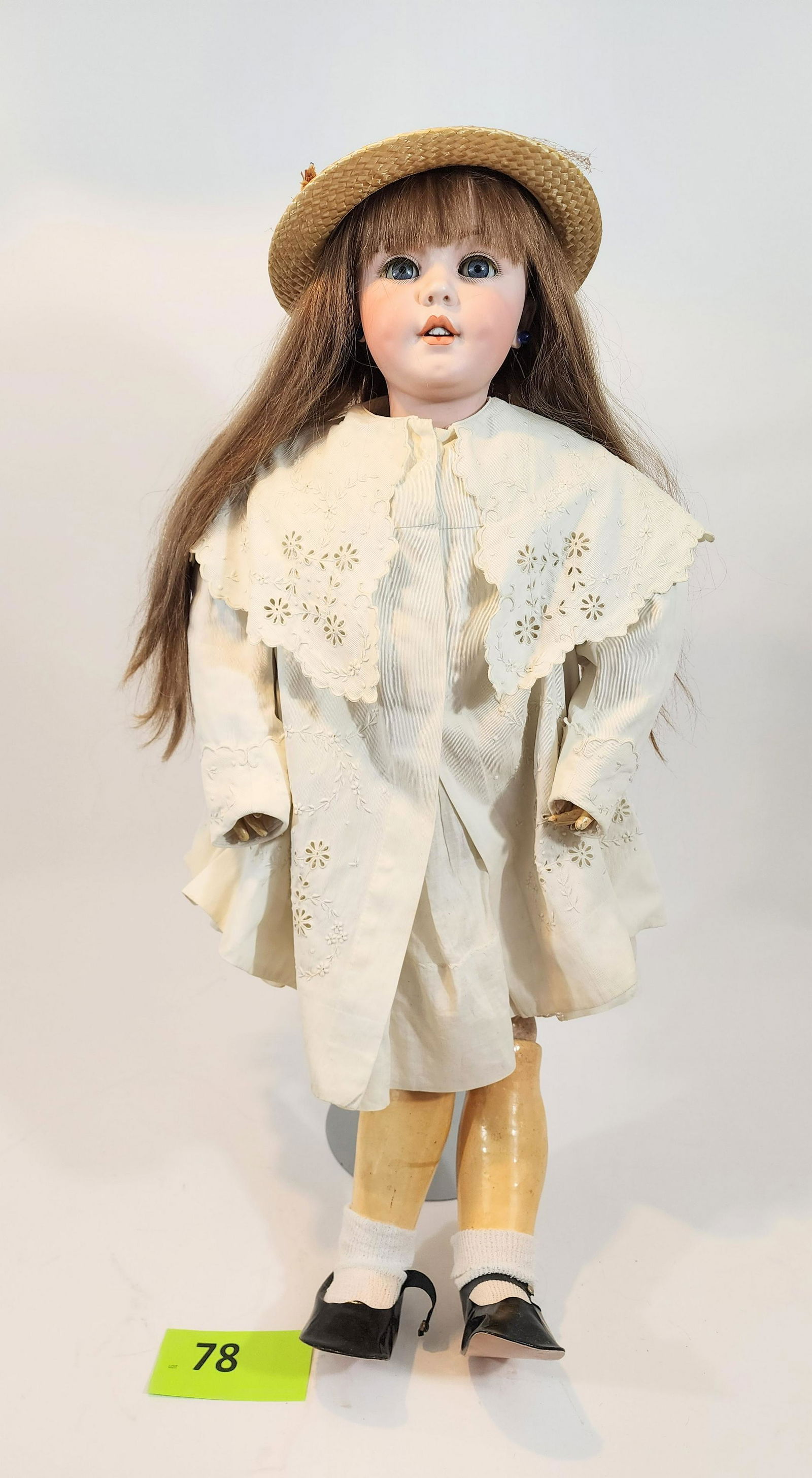 34" SIMON-HALBIG SLEEPY-EYE DOLL: Bisque head and composition body, open mouth with teeth, vintage embroidered coat and collar, straw hat and earrings. 34" high.