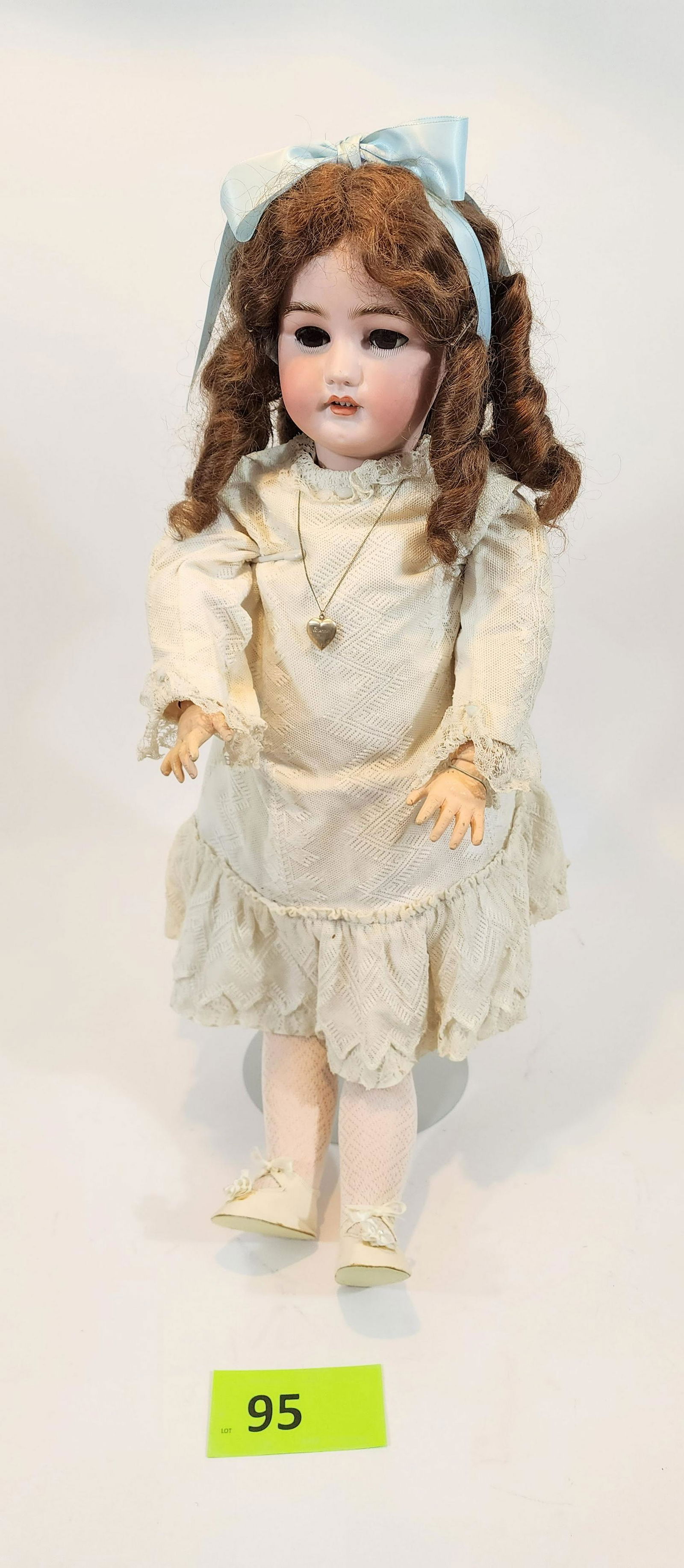 30" SIMON-HALBIG SLEEPY-EYE DOLL: Bisque head and composition body, sleepy eyes, open mouth with teeth, brunette with curls, earrings and locket. In vintage lace dress. 30"high.