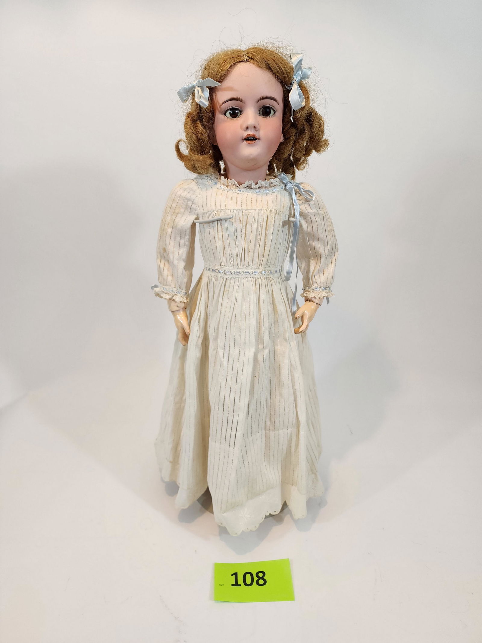 26" HANDWERCK SLEEPY-EYE DOLL: Bisque head and composition body, strawberry blonde hair, open mouth with teeth, vintage dress and leather shoes. 26" high.