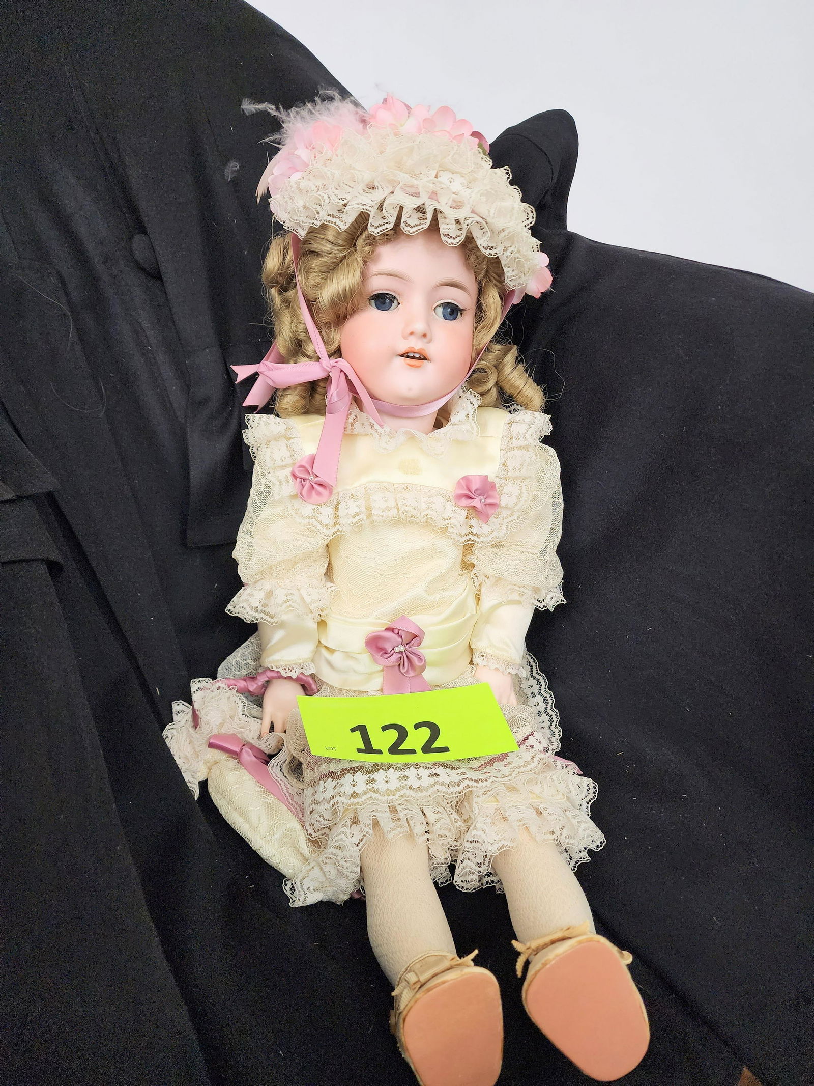 21" ARMAND MARSEILLE BISQUE-HEAD DOLL: Bisque head and composition body, open mouth with teeth, modern wig and outfit. 21" high.