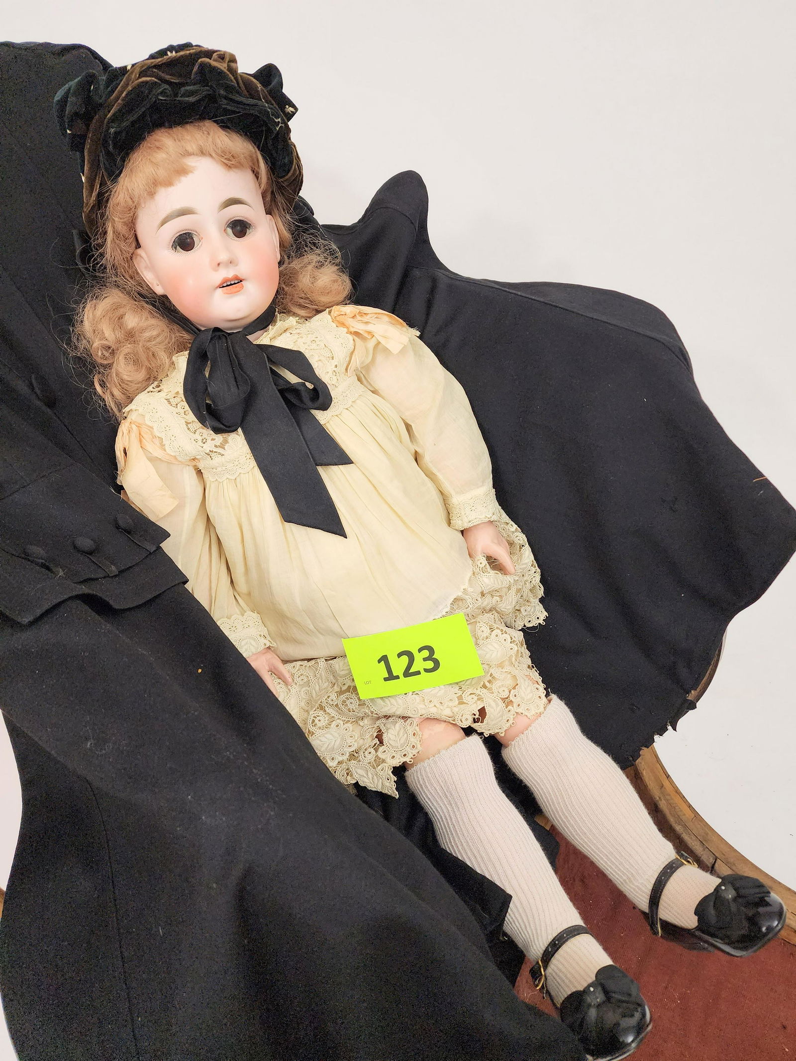 32" GERMAN BISQUE-HEAD DOLL: Bisque head and composition body, open mouth with teeth, pierced ears, brunette, in lace-trimmed gown and hat. 32" high.