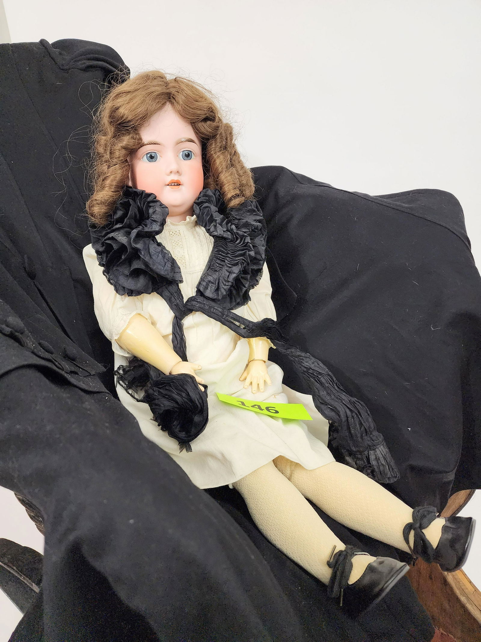 29" ARMAND MARSEILLE DOLL: Bisque head and composition body, open mouth with teeth, brunette ringlet curls, in simple white gown and with black ruffled collar. 29" high.