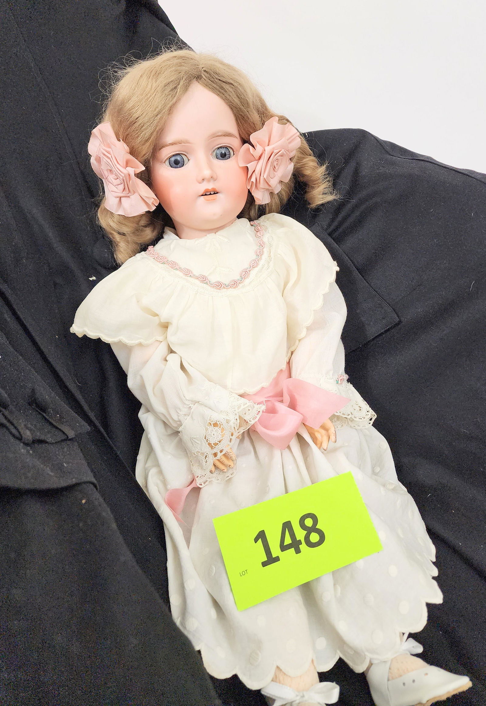 24" ARMAND MARSEILLE SLEEPY-EYE DOLL: Bisque head and composition body, sleepy eyes, open mouth with teeth, ash blonde curls, in white dress with lace and pink rose trim. 24" high.