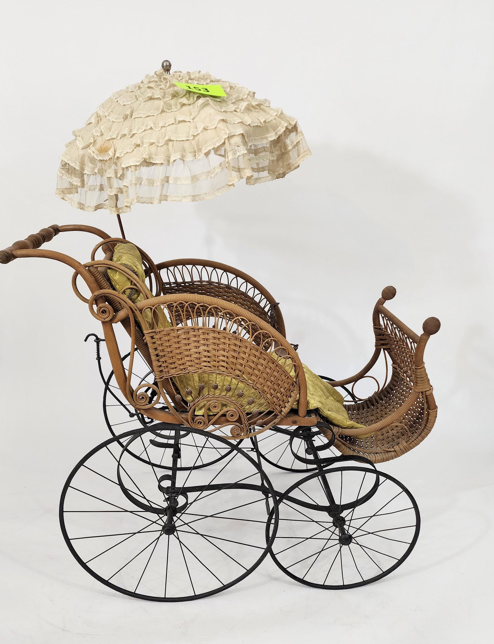 HEYWOOD BABY CARRIAGE: Basket-weave and stick-and-ball "wing" side panels; vintage fabric cushion and original parasol. Original safety belt. Heywood label. 40" long.