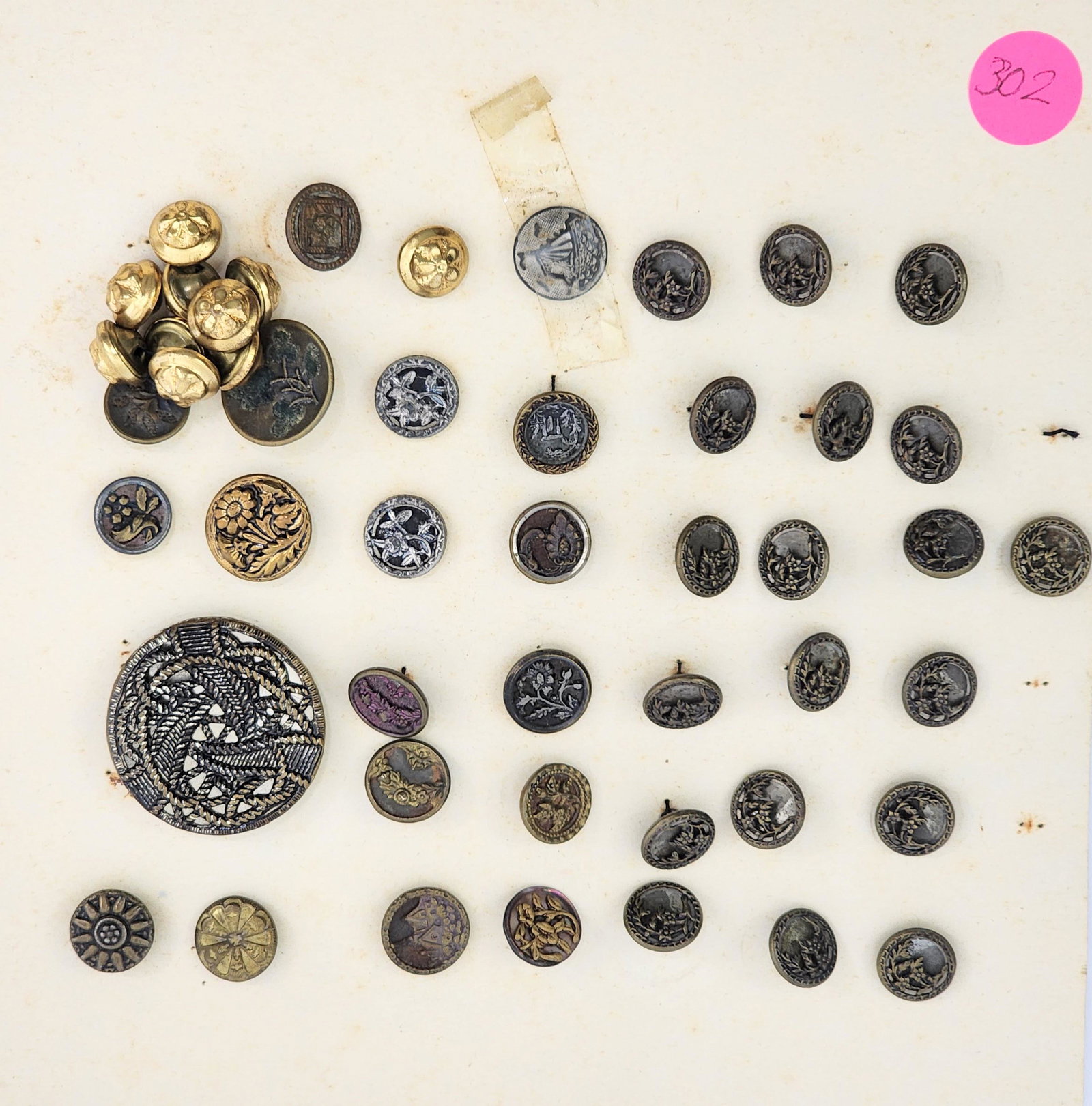 GROUP OF STEEL CUT BUTTONS: Mid-late 19 th century. Group consists of 47 Victorian steel cut buttons including pictorial, floral including a large velvet background perfume button and large button with rope design. .5” â�