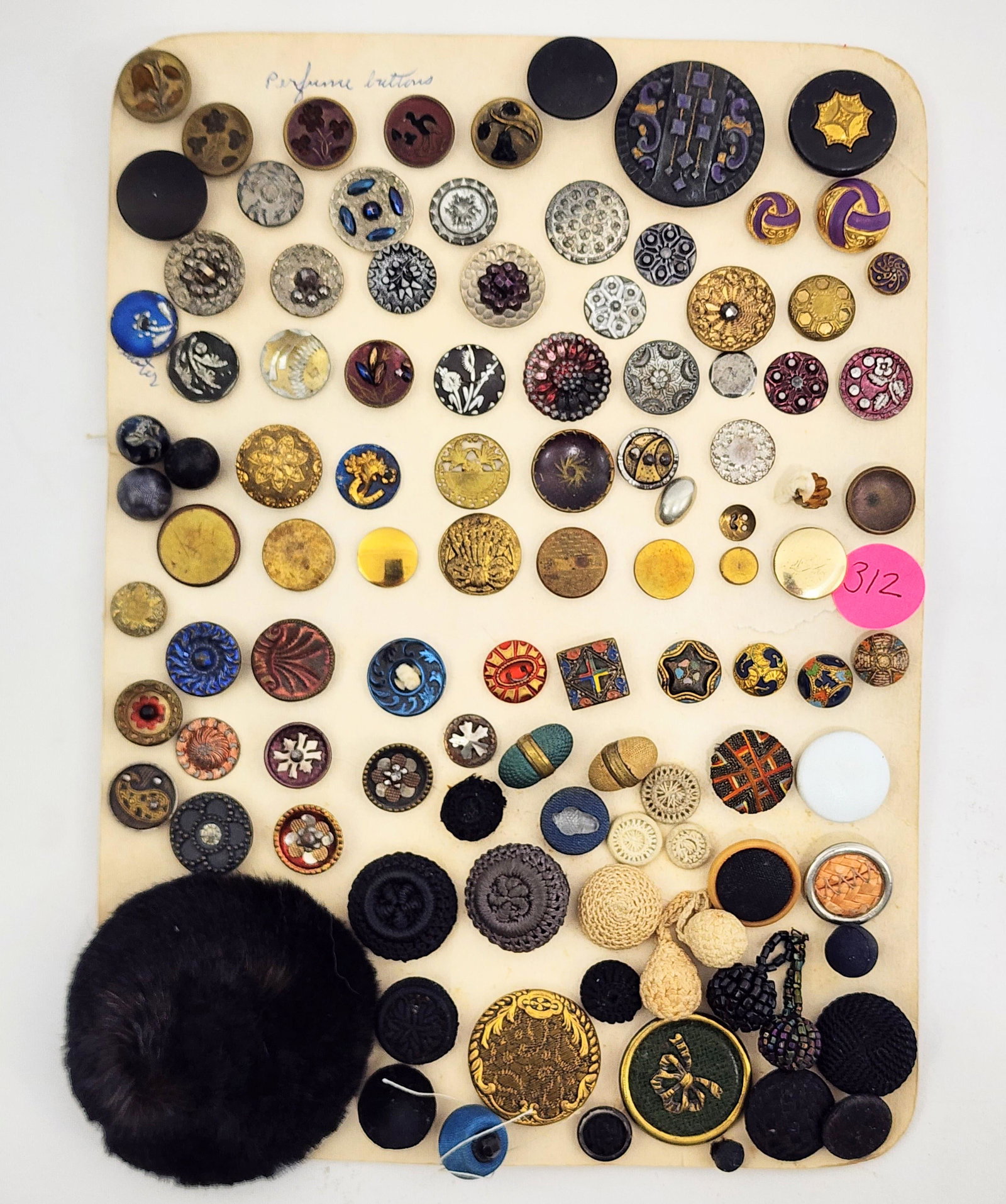 CARD OF VICTORIAN BUTTONS: Mid-late 19th century. Large group of approximately 90 buttons including perfume buttons with velvet backing, acorn buttons, crochet covered buttons, fur covered buttons, steel cut buttons and painted