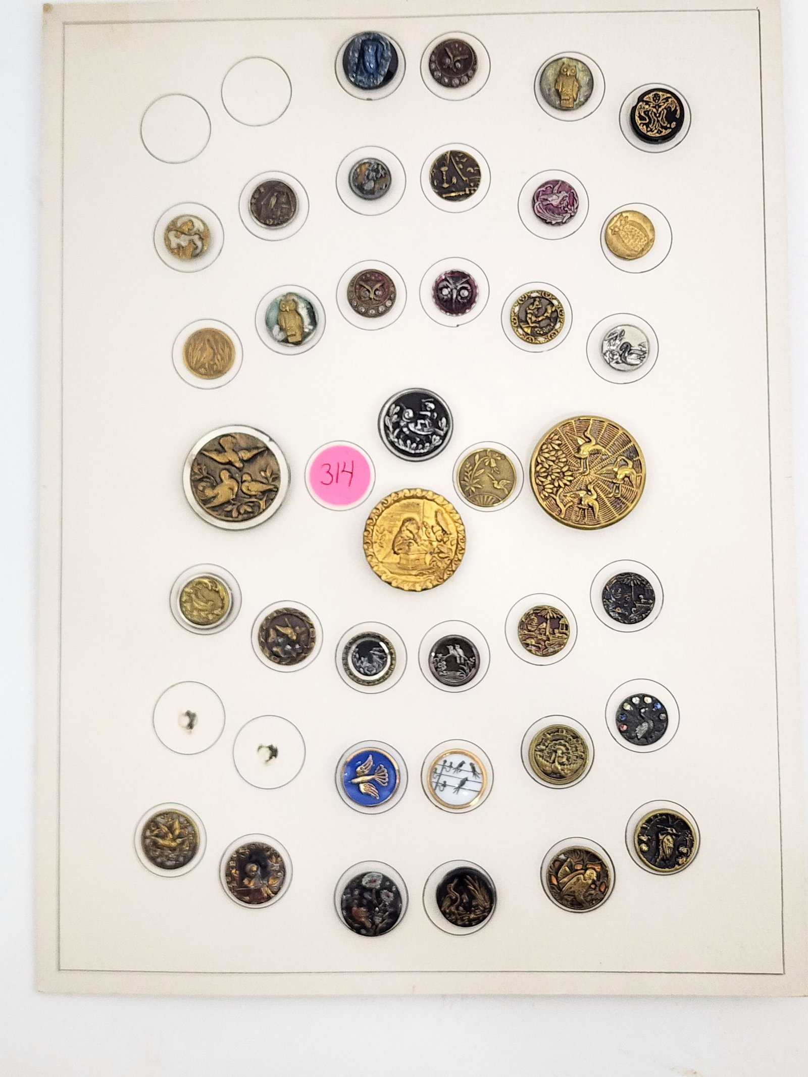 CARD OF VINTAGE BUTTONS: Late 19th-mid-20th century. Group of 37 buttons, all with bird motifs including carnival and steel cut owls, girls with birds and painted. .5”-1.25" diameter