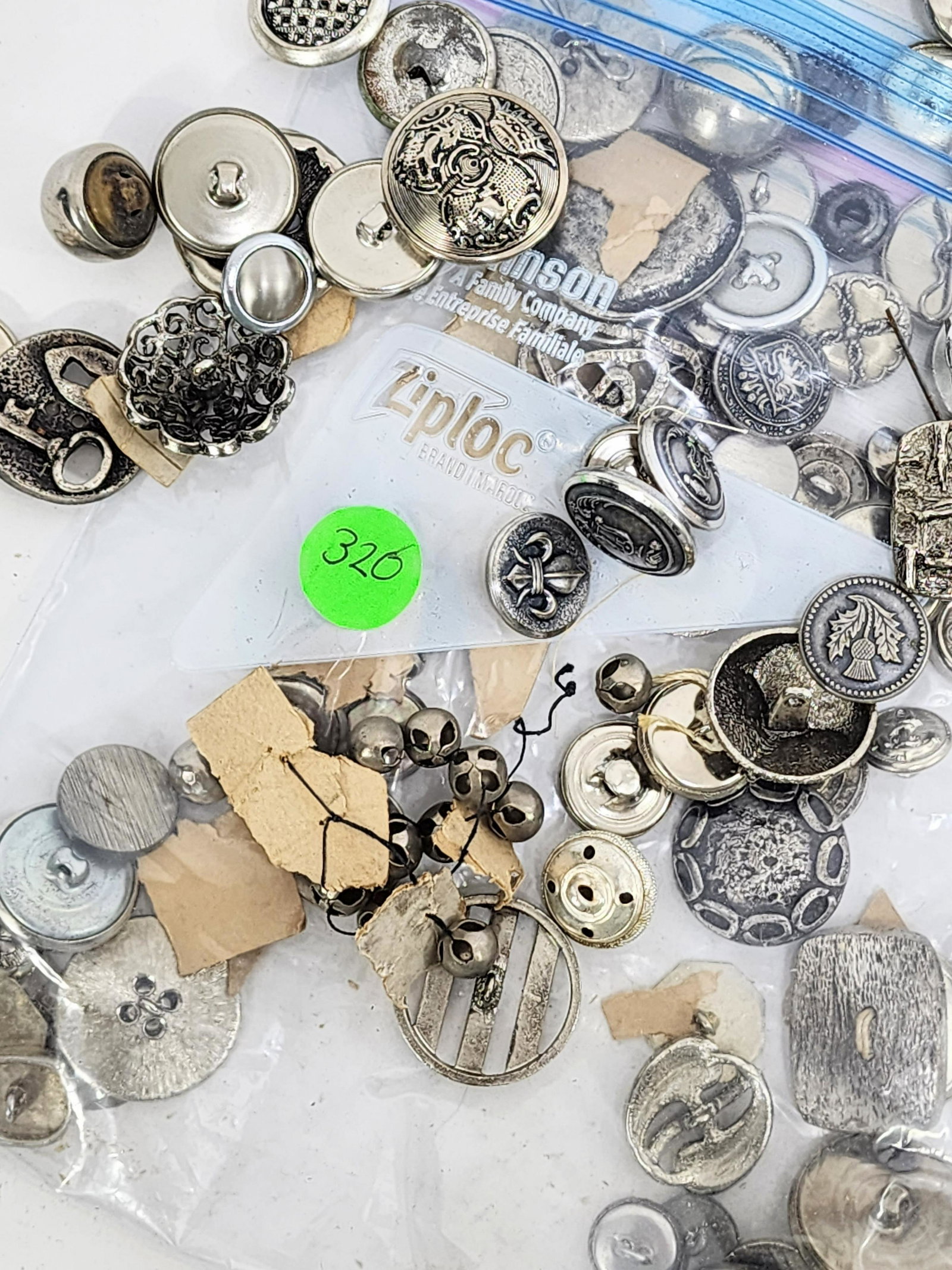 LARGE GROUP OF METAL BUTTONS: Late 19th-20th century. Group of silvertone metal buttons. Various sizes and patterns.