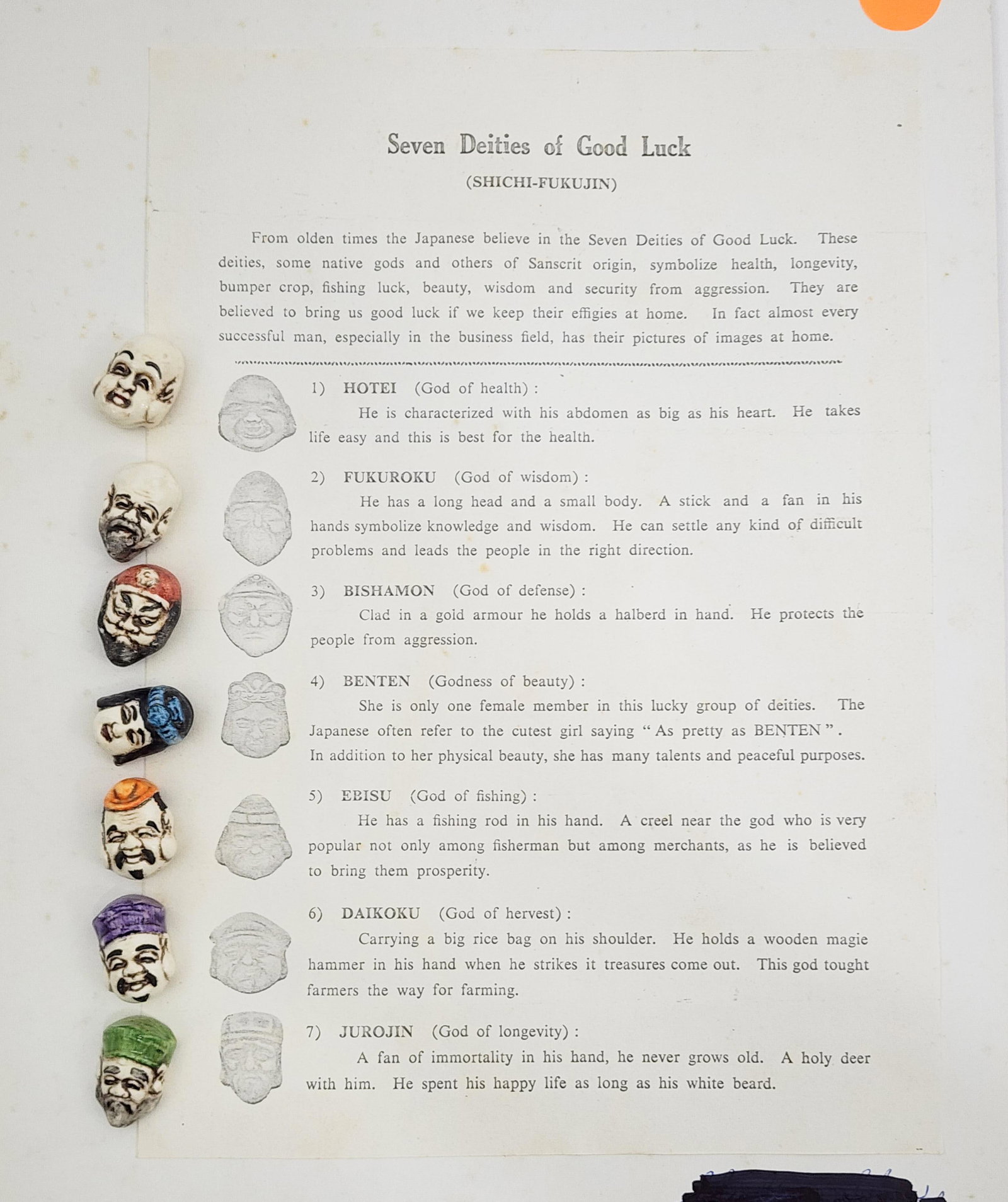 SEVEN DEITIES OF GOOD LUCK BUTTONS: 20th century. Seven ceramic figural buttons of Japanese gods mounted on card with information sheet. Unsigned. Approximately .5" wide, 1" high.