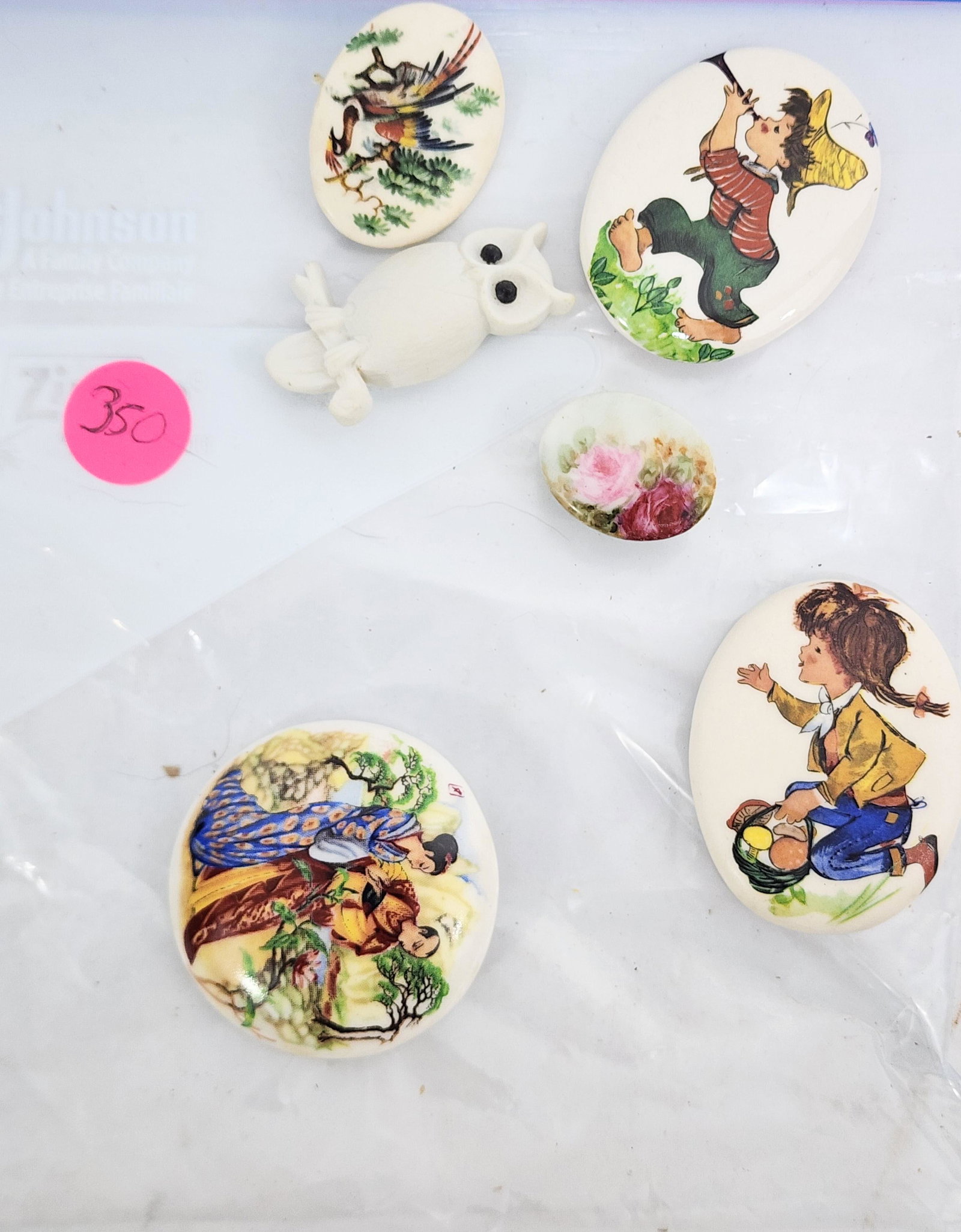 GROUP OF VINTAGE JASPERWARE BUTTONS: 20th century. Group includes a button with a boy painted on the front and one with a girl, both signed "Shirley" for Shirley Shaw; an owl with painted eyes and a large round button with an Asian scene