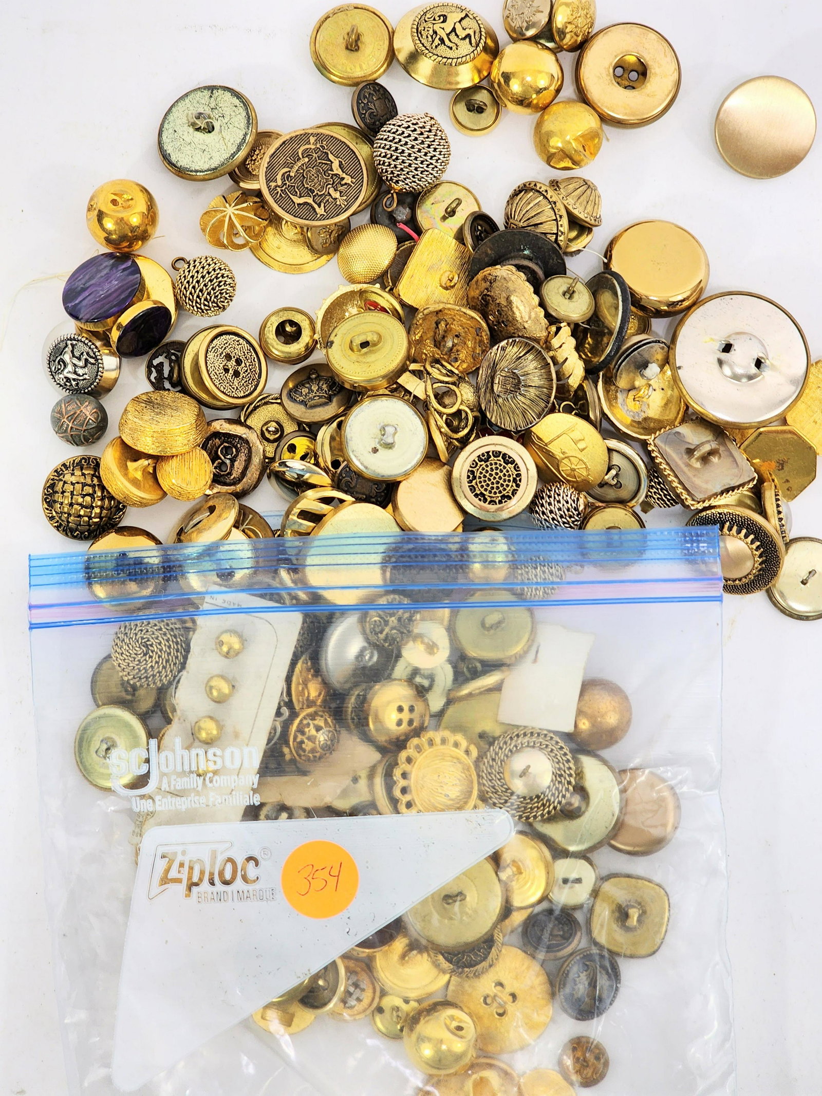 LARGE GROUP OF BRASS BUTTONS: 20th century. Group includes faceted, enamel decorated, anchors, "BB", etc. .5" - 1.5" diameter