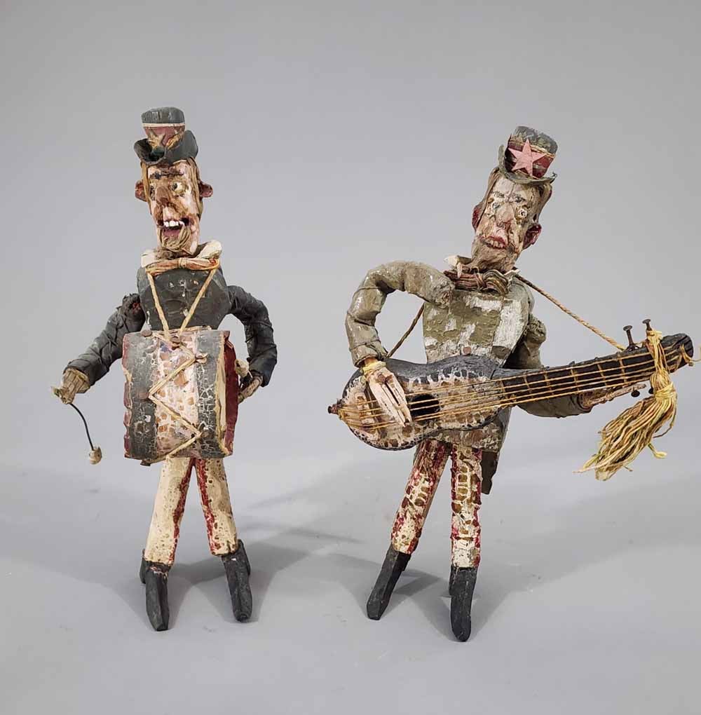 PAIR OF FOLKSY MUSICIANS: 20th century. A guitarist and a bass drummer, both wearing patriotic costumes. Retain their original, alligatored paint. 13" high.