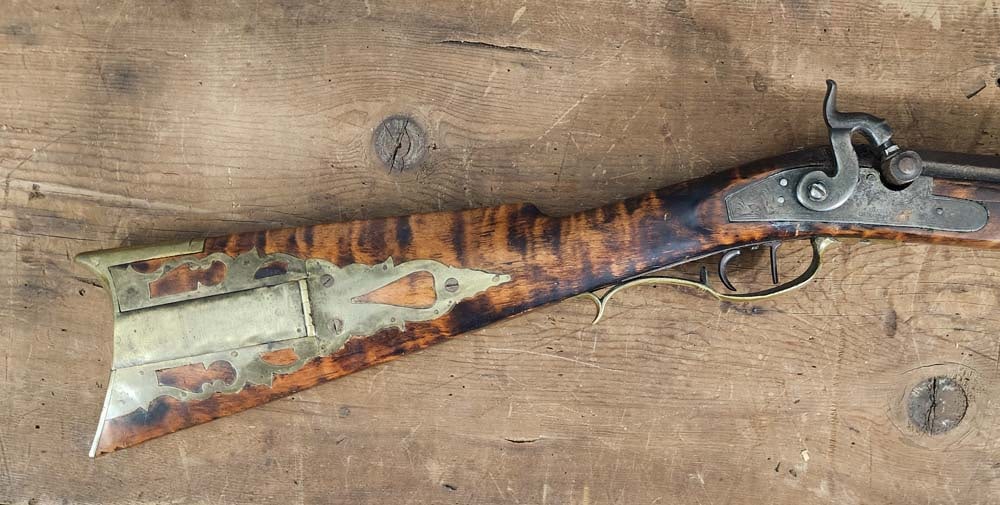 PIQUA, OHIO LONG RIFLE: Marked for the Oblinger family, 3rd quarter-19th century. Curly maple half stock, Davidson (Cincinnati) lock, star inlay, and brass patch box. 34.5" octagonal barrel, about 42 cal. See Hutslar, Ohio G