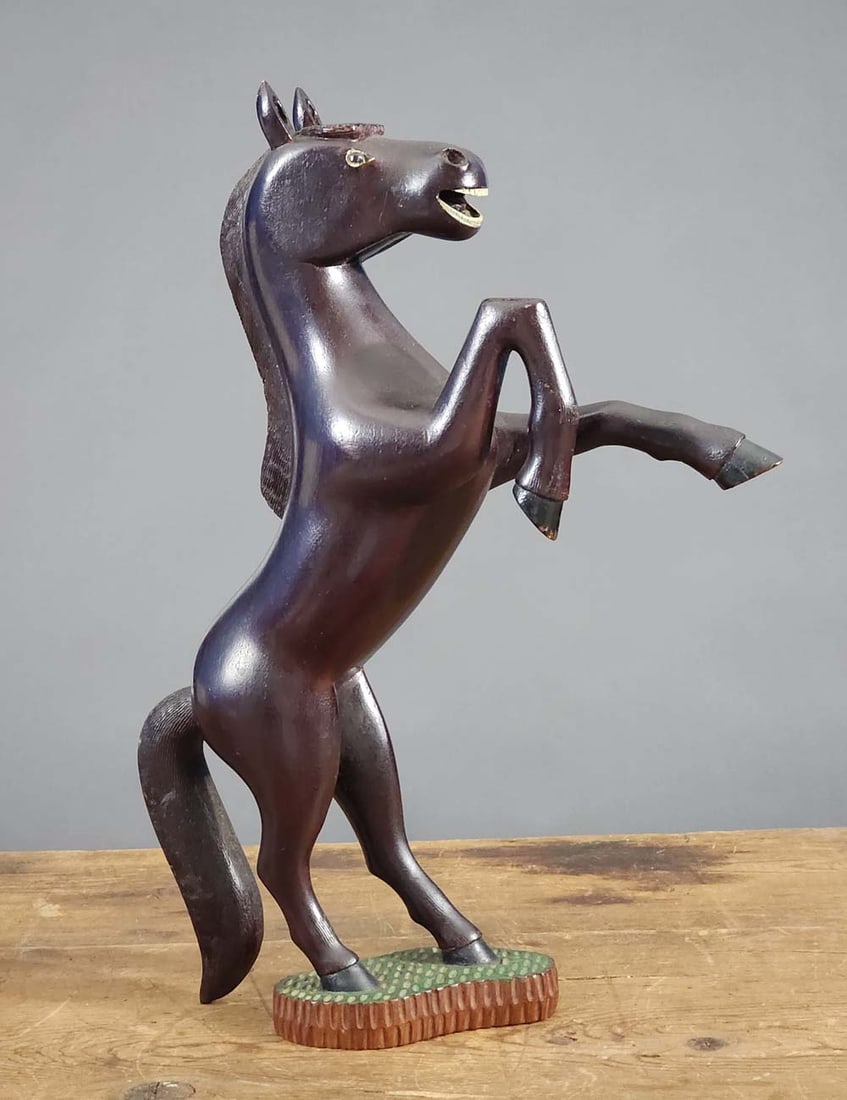 FOLK ART SCULPTURE OF A HORSE: American, early 20th century, mahogany. Exceptionally carved rearing horse with glass eyes and a chip-carved base. 17.24" high. Ex Austin Miller (Ohio).