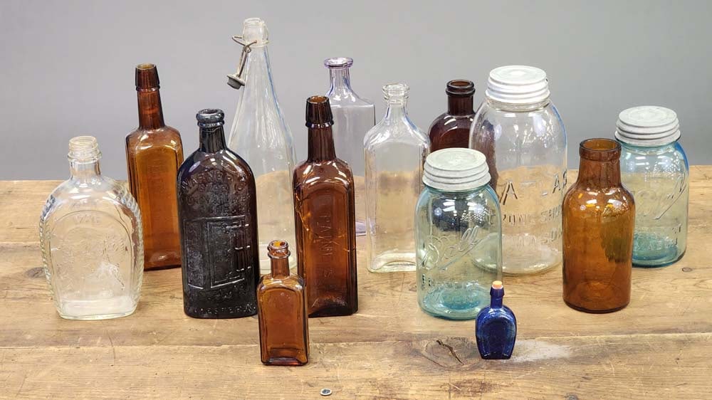 COLLECTION OF BOTTLES AND JARS: Includes Warner's Kidney and Liver Cure, Atlas and Mason jars, and more.