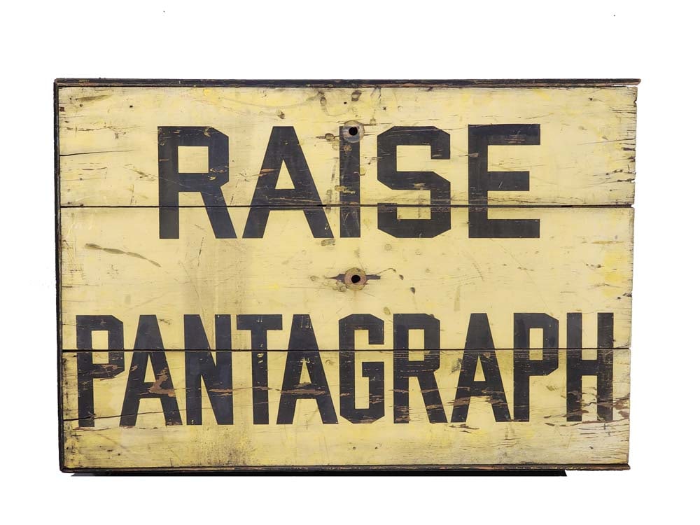 "PANTAGRAPH" STREETCAR SIGN: American, 2nd quarter-20th century. Original paint reading "RAISE PANTAGRAPH" [sic]. 24.5" high, 36.5" wide. A pantograph is the apparatus on the top of an electric bus, trolley, or streetcar that con