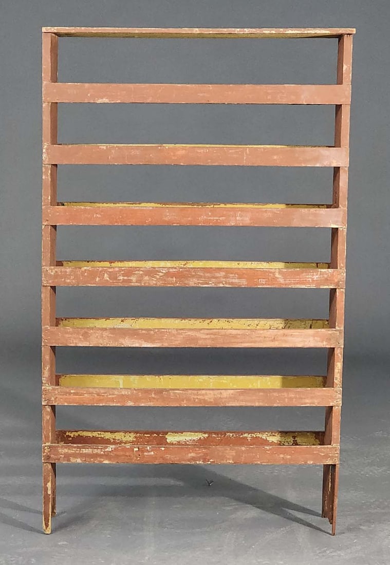 PAINTED RACK: American, 20th century. Made from earlier parts, including a packing crate. Old red paint. 54" high, 32" wide, 8.5" deep.