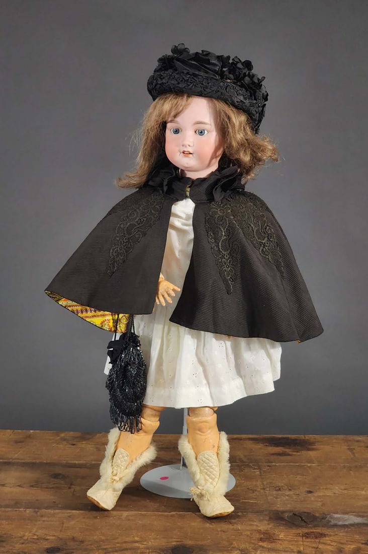 34" ARMAND MARSEILLE DOLL: German. Bisque head (open mouth, teeth), composition body, wearing a white dress and black cloak.