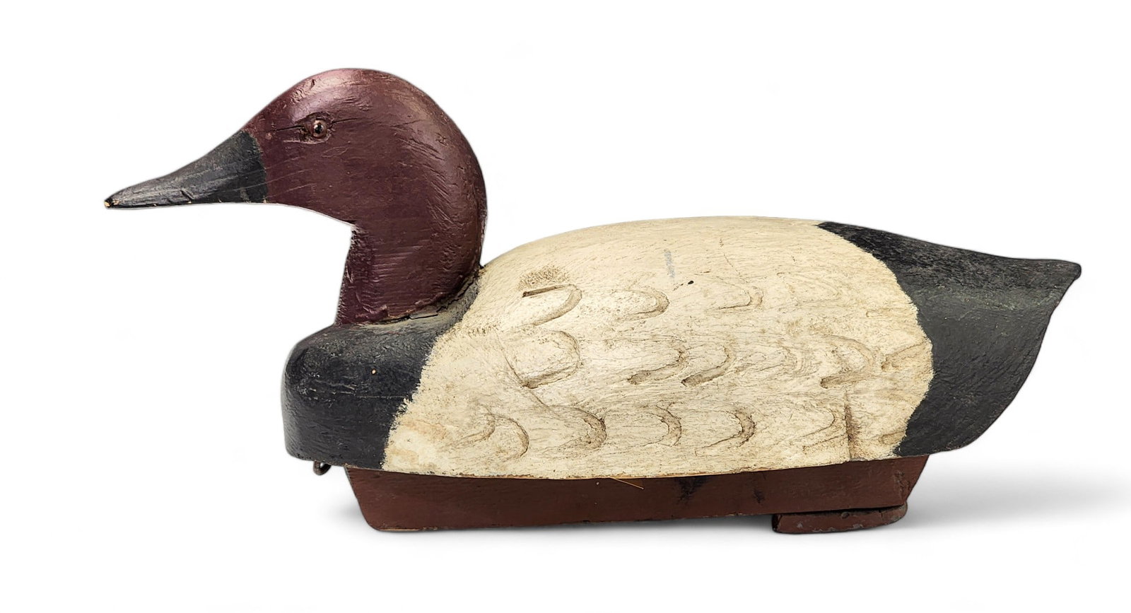 CANVASBACK DECOY: Attributed to Waikeburg, Ontario, Canada. Drake decoy with feather stamping on the wings. Retains old paint. 15.25" long.