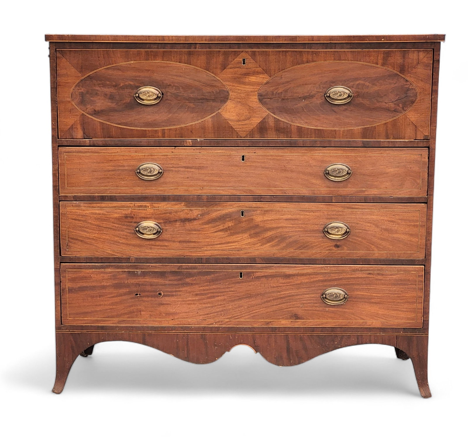 HEPPLEWHITE BUTLER'S DESK: School of Michael Allison, New York, early 19th century, mahogany and poplar. Desk over three graduated drawers, all with line inlay and the upper desk drawer with ovals and a diamond, all on French f