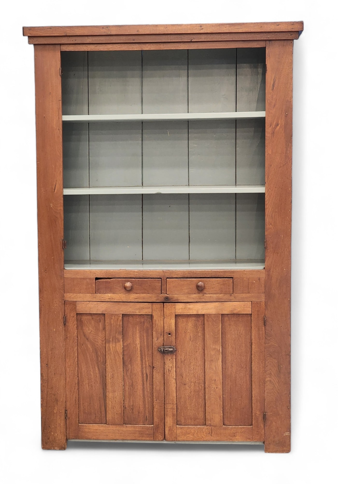 COUNTRY CUPBOARD: American, 19th century, walnut and poplar. Paneled doors, two drawers, and vintage blue-painted on the interior. 80" high, 50.5" wide, 17.5" deep.