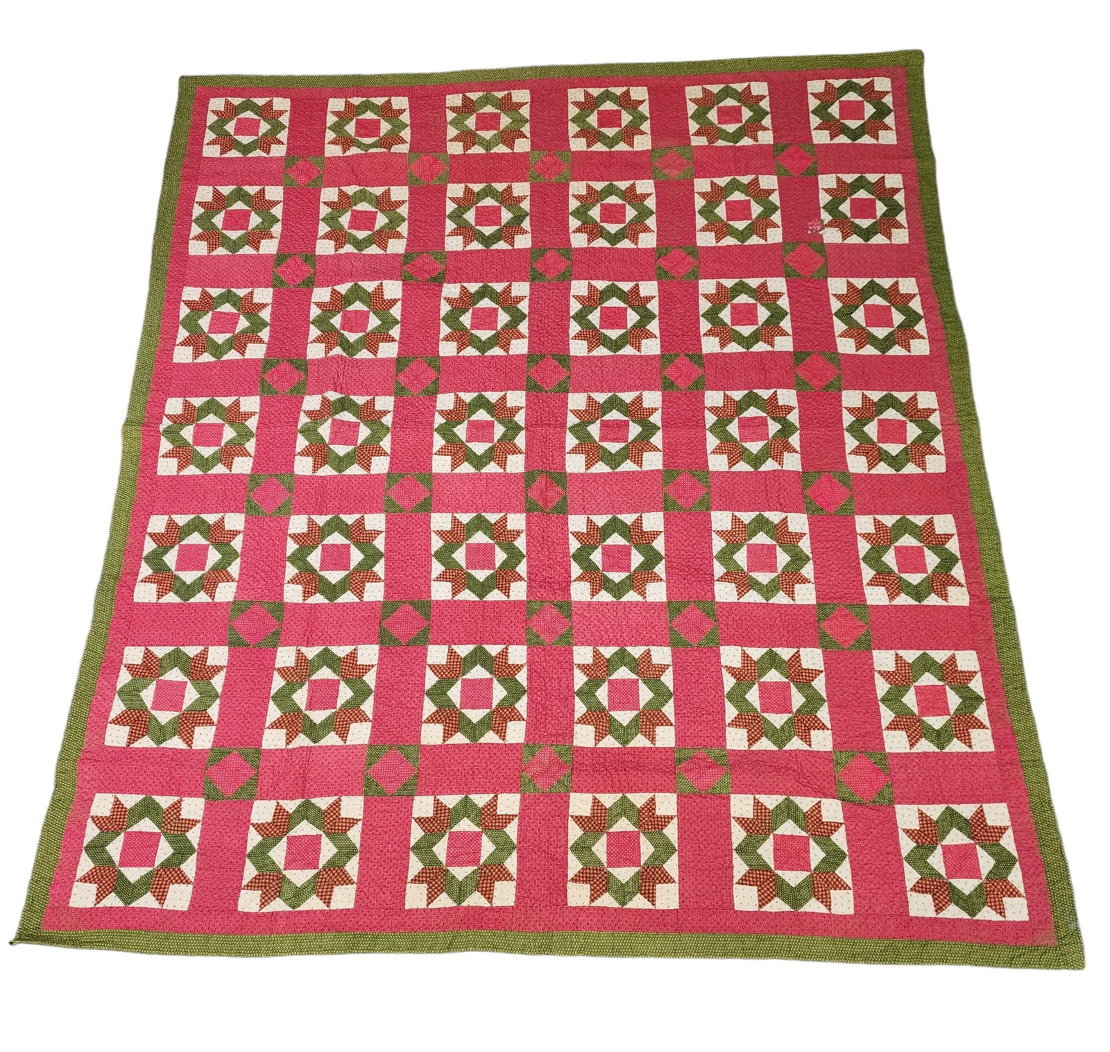 PIECED QUILT: American, late 19th century, cotton. Hand-stitched in red, green, rust, and white printed fabrics. 84" by 75".