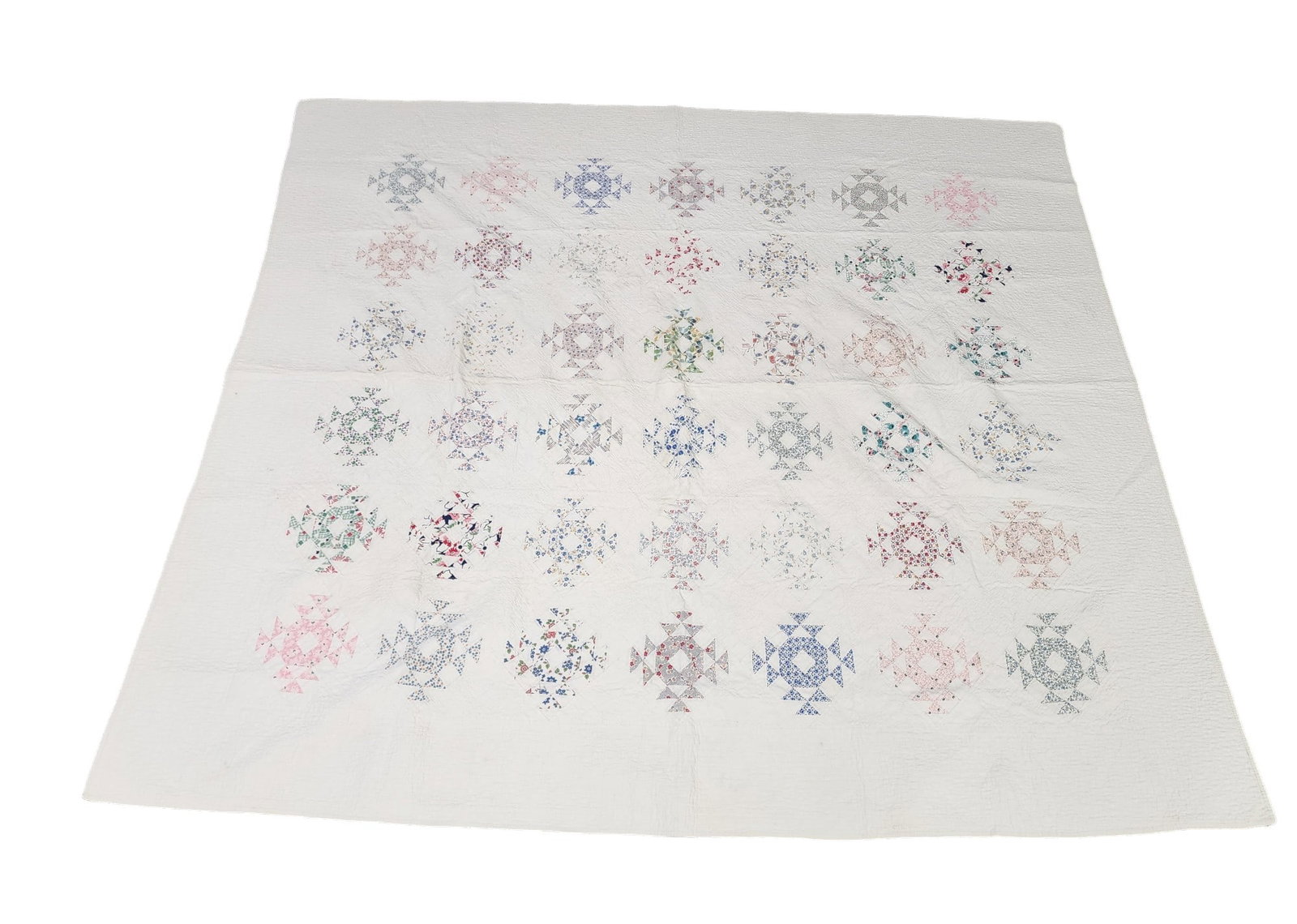 NEST & FLEDGLING PIECED QUILT: American, c. 1935, cotton. Printed floral fabrics. "Leem" laundry mark. 82" by 72".