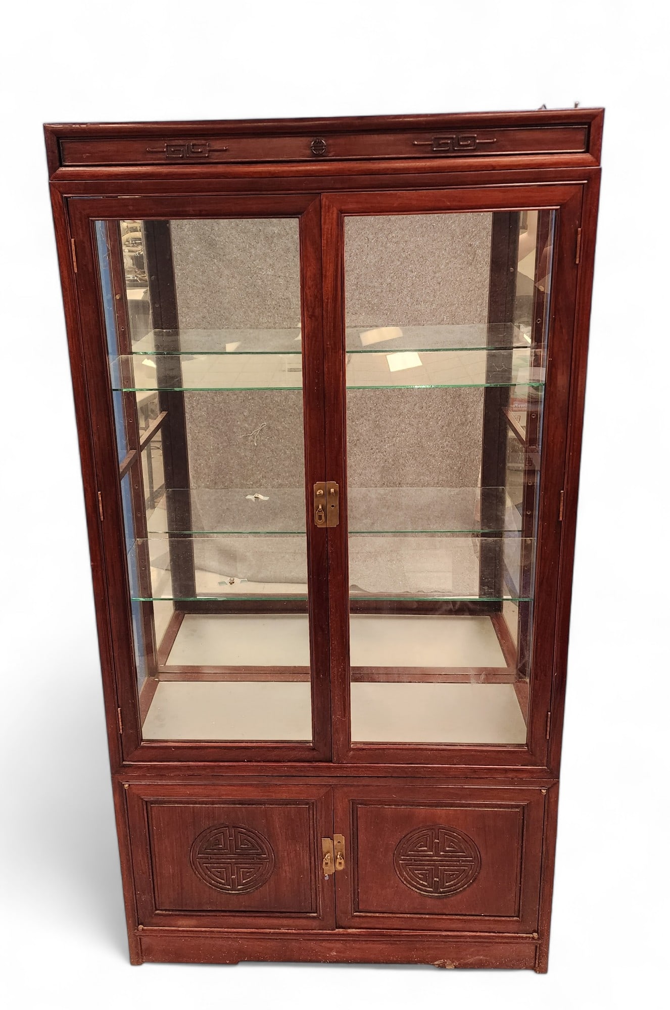 CHINESE-STYLE CABINET: 20th century, mahogany. Lighted, with glass shelves. Side panel cracked, lighting not tested. Made in three parts and comes apart for easier moving. 78" high, 40" wide, 14" deep.