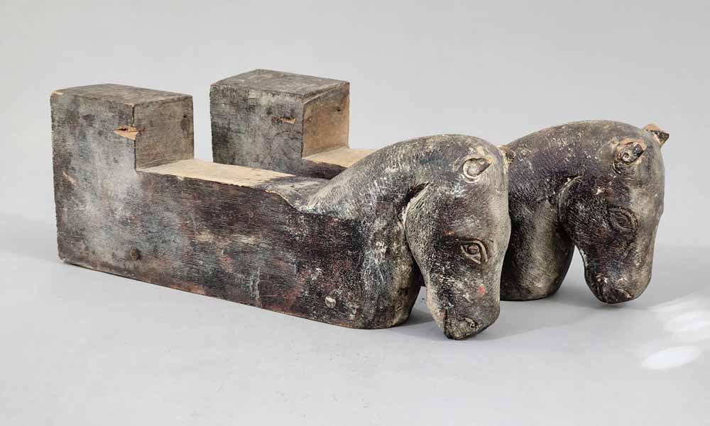 PAIR OF CARVED ARCHITECTURAL OBJECTS: European, 19th century, oak. Possibly window stops, with folksy horse heads, and retaining their original finish. 6" high, 17" long.European, 19th century, oak. Possibly window stops, with folksy hors