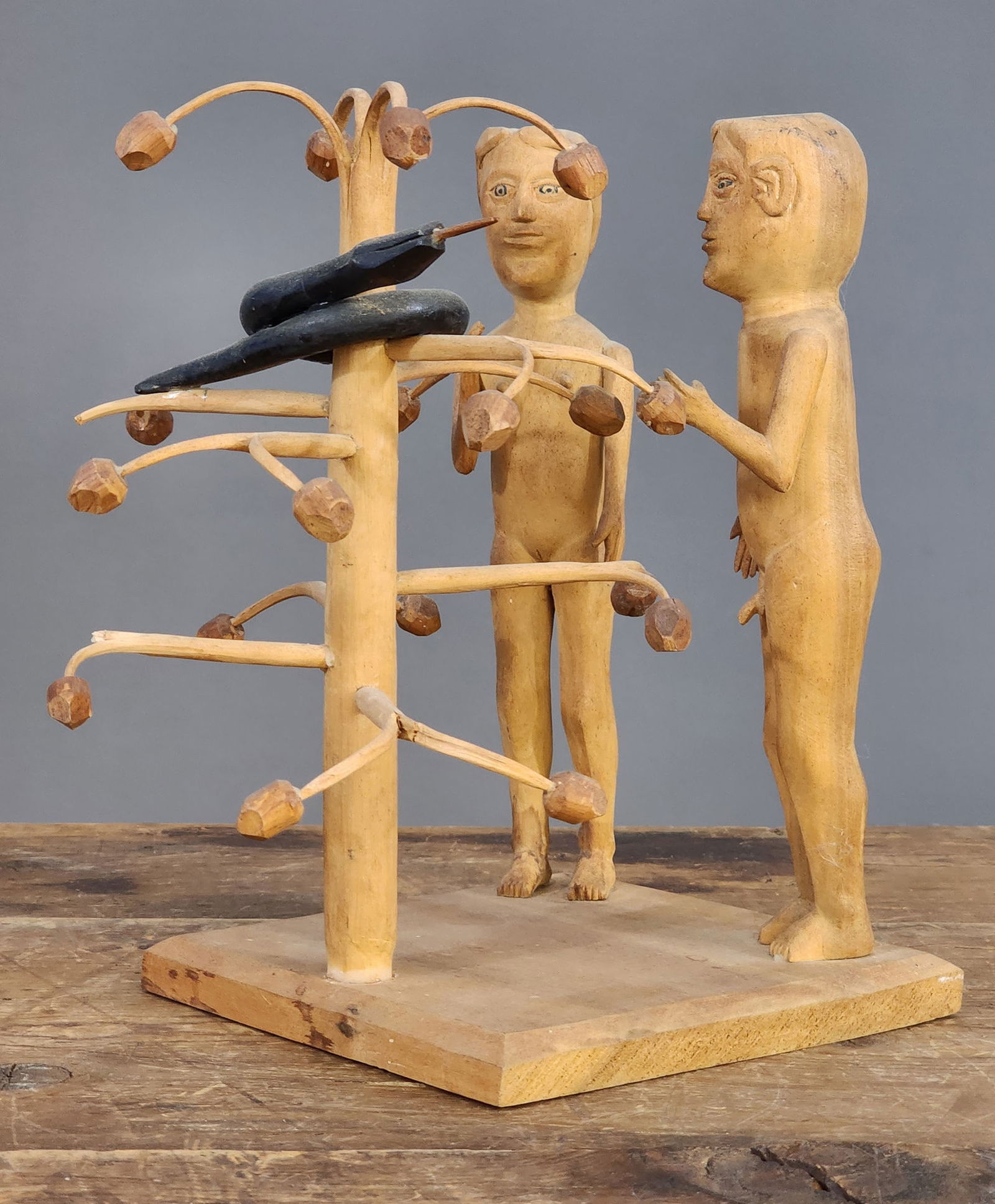 EDGAR TOLSON (KENTUCKY, 1904-1984): Adam and Eve in the Garden of Eden, 1970s, basswood on a poplar base. Classic Tolson carving of Adam and Eve, with the painted snake in the apple tree. Not signed, but inscribed on the underside "Jame