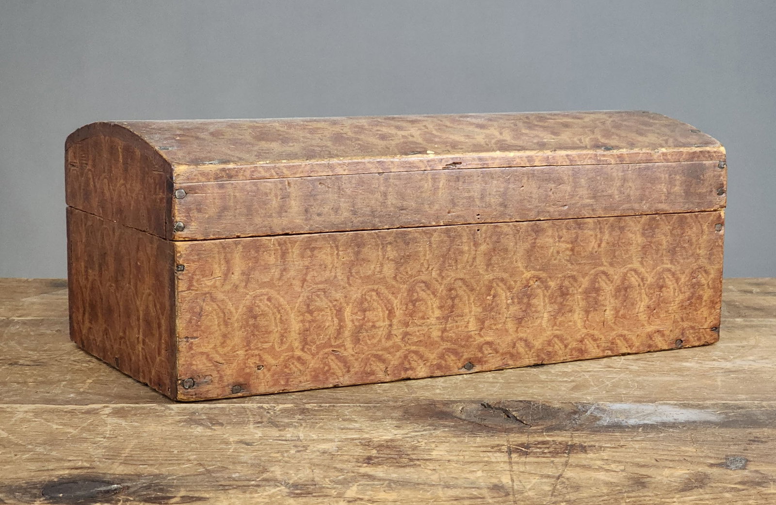 DECORATED DOCUMENT BOX: New England, 1810-1830, basswood. Diminutive dome-top box retaining its original sponge-painted decoration. 6.5" high, 16.5" wide, 8" deep.