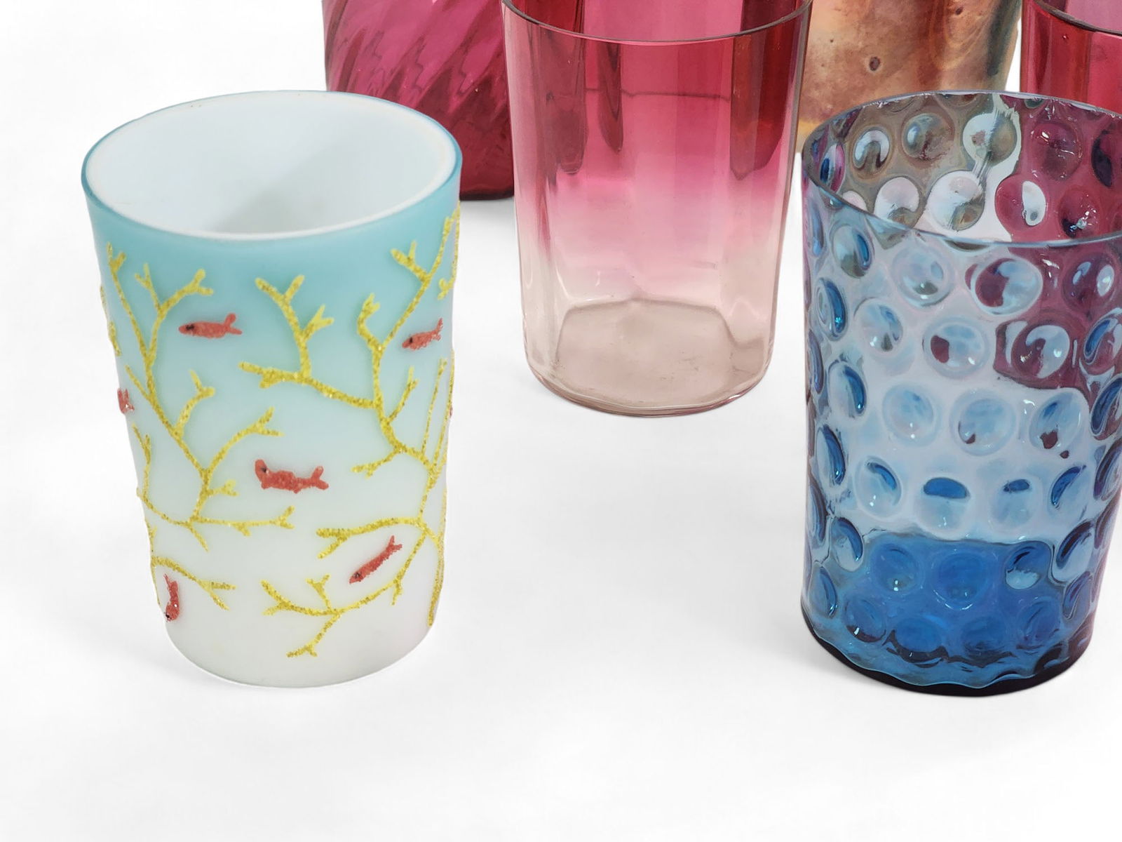 COLLECTION OF ART GLASS TUMBLERS: Mostly late 19th century with a few later examples. A variety of colors and types, incuding thumbprint, hobnail, favrile-type, etc. 3.5" to 5.5" high.