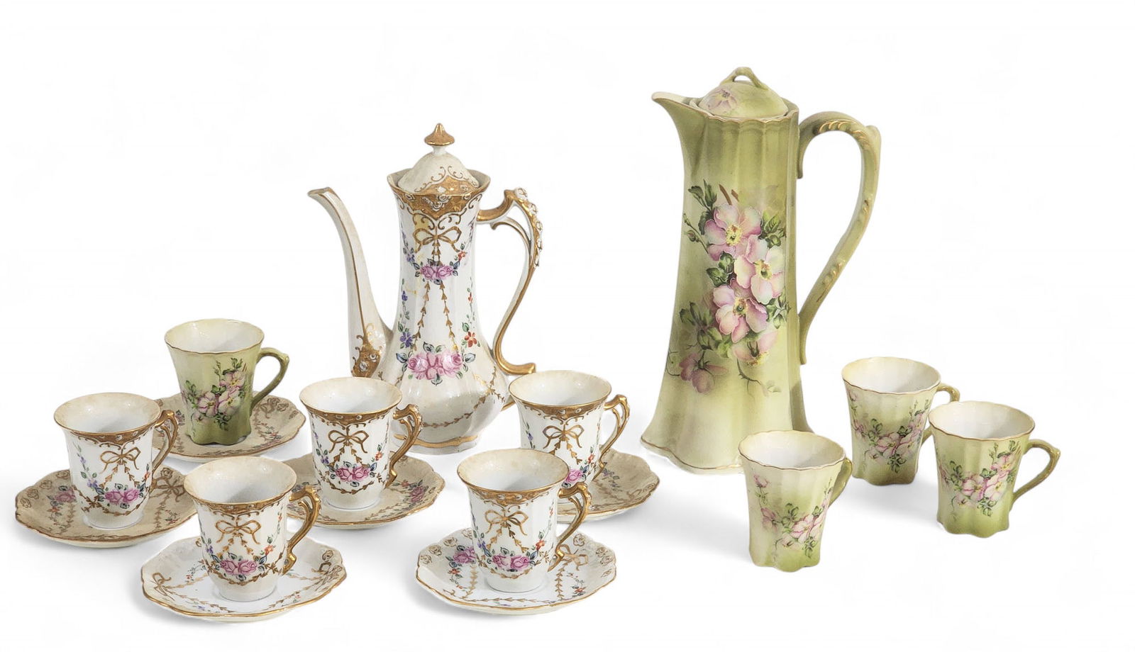 TWO HANDPAINTED DEMITASSE SETS: Late 19th-early 20th century. Includes a floral and swag set by RS Prussia; together with a floral Nippon set. Pots are 9" and 10.5" high.
