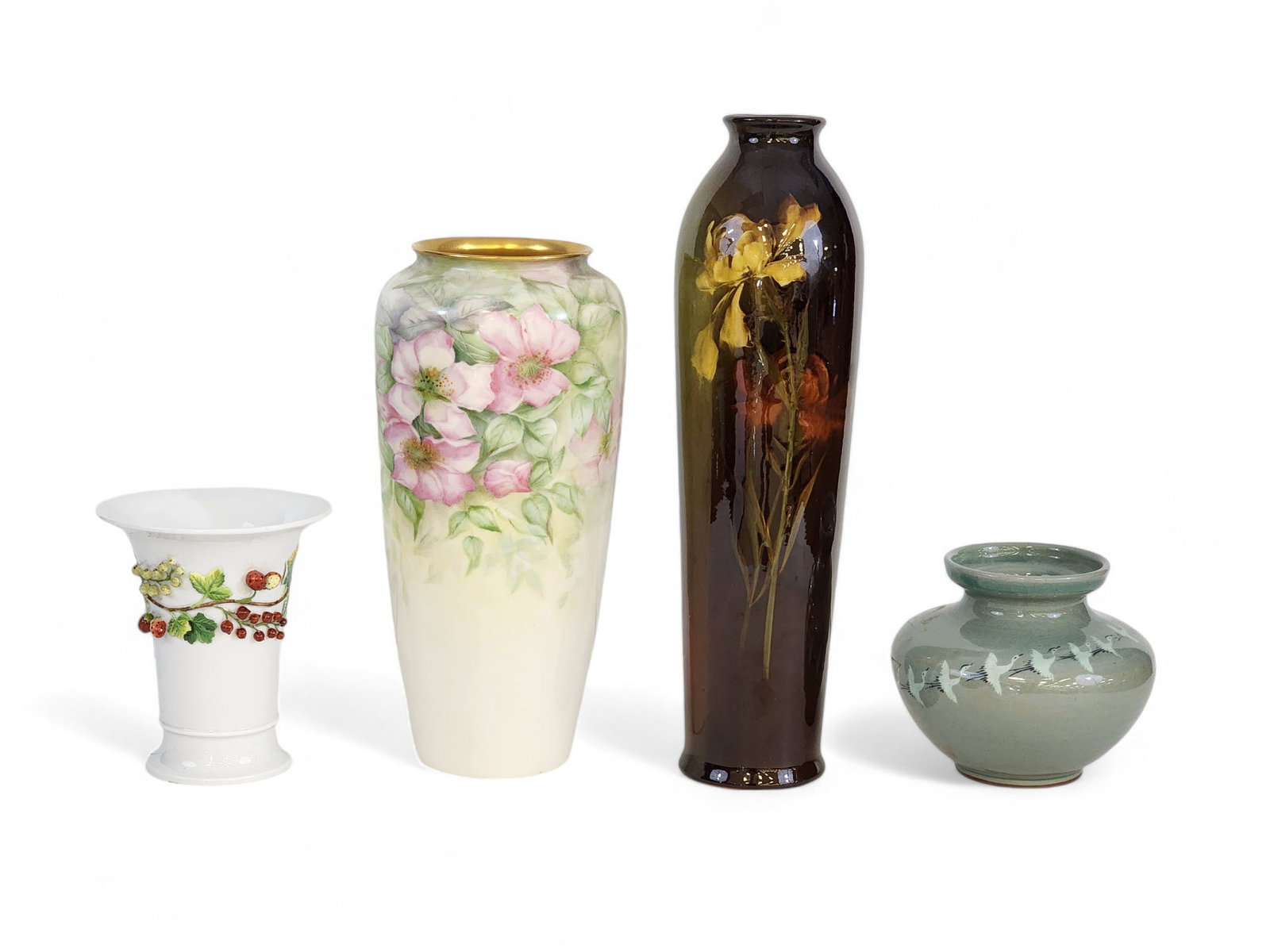 FOUR PIECES OF POTTERY: 20th century. Includes a Meissen vase with applied berries, 5" high; an Asian vase with cranes, 4.5" high; a Belleek vase with handpainted flowers, 10.25" high; and a Roseville Rozane vase, 12.5" high