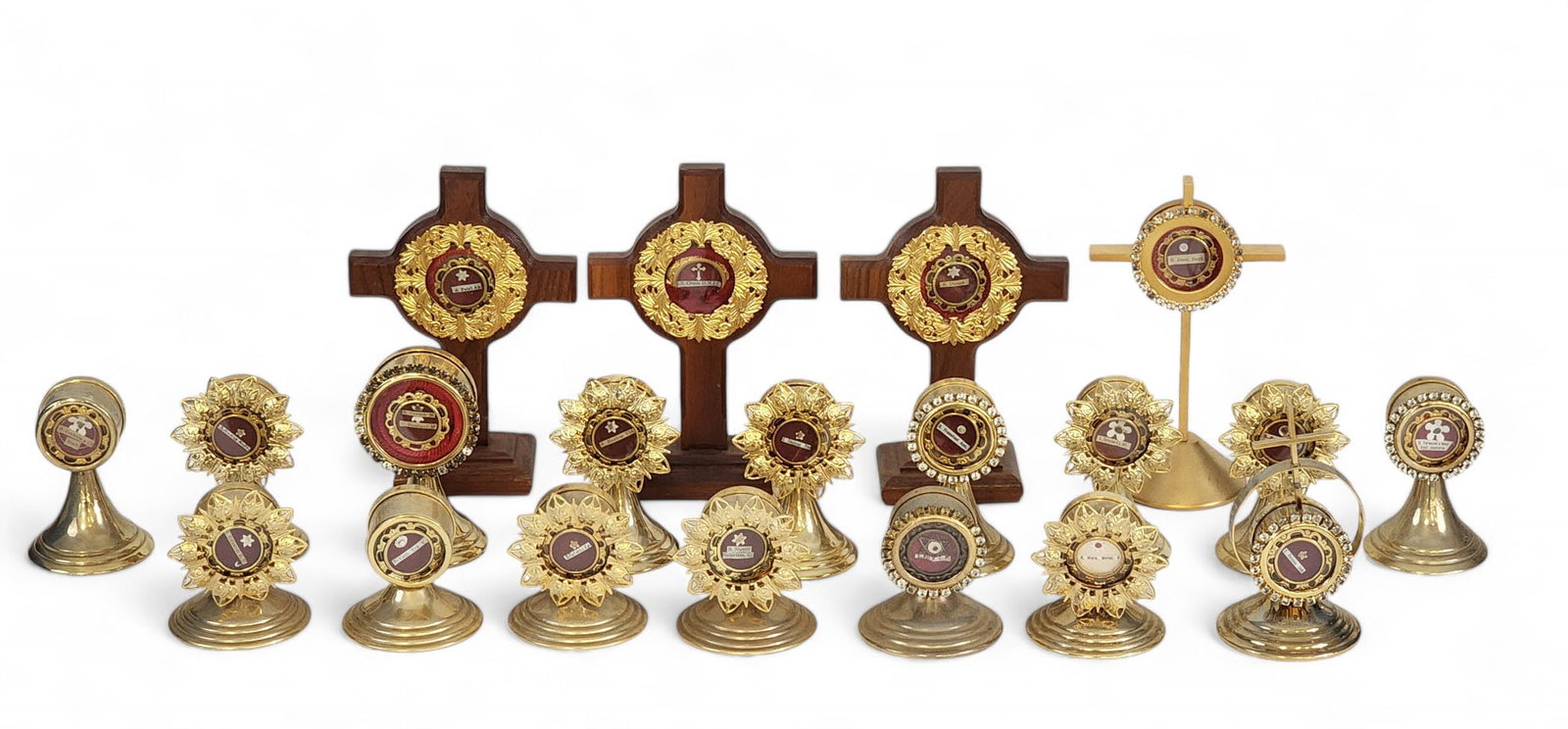 COLLECTION OF CHRISTIAN RELICS: Possibly antique. Large collection of relics purportedly from various Catholic saints, all mounted in small lockets, and most displayed in gold-toned or cruciform reliquaries. Accompanied by several c