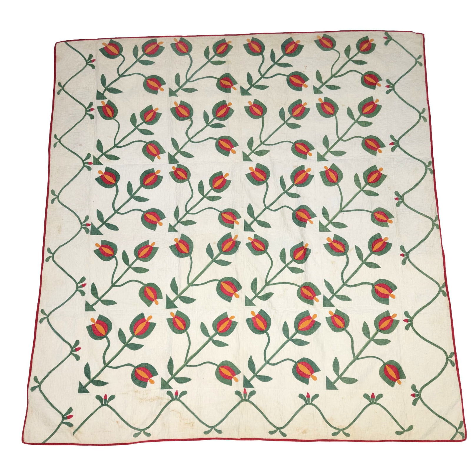FLORAL APPLIQUE QUILT: American, mid-19th century, cotton. Tulip pattern, with a vining border, in green, red, and cheddar. Machine binding. 79" by 73. Purchased in Mansfield, Ohio in 1993.