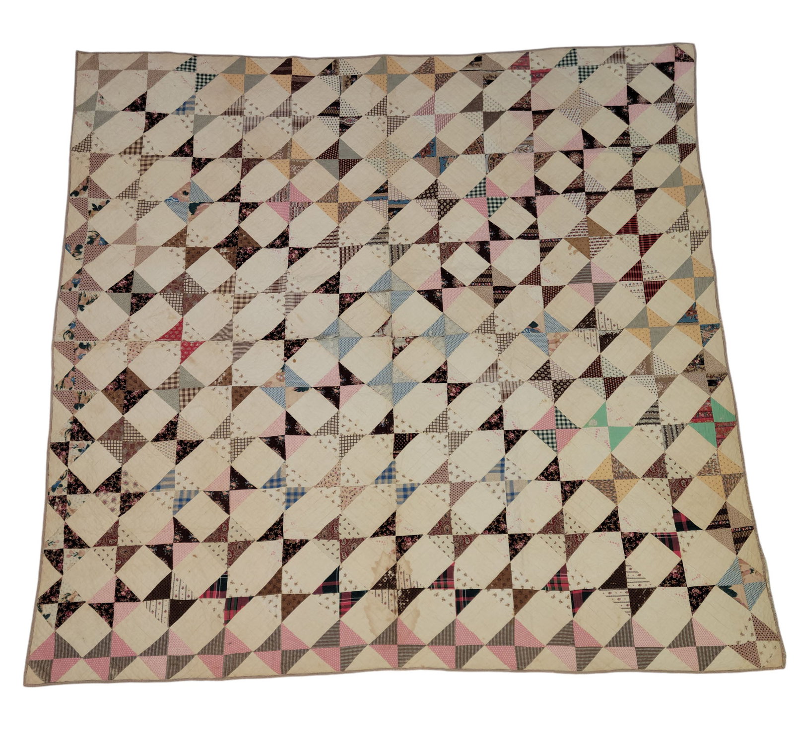 PIECED QUILT: American, mid-19th century, cotton. Pieced triangles of printed cottons in a geometric pattern. 85" by 83".