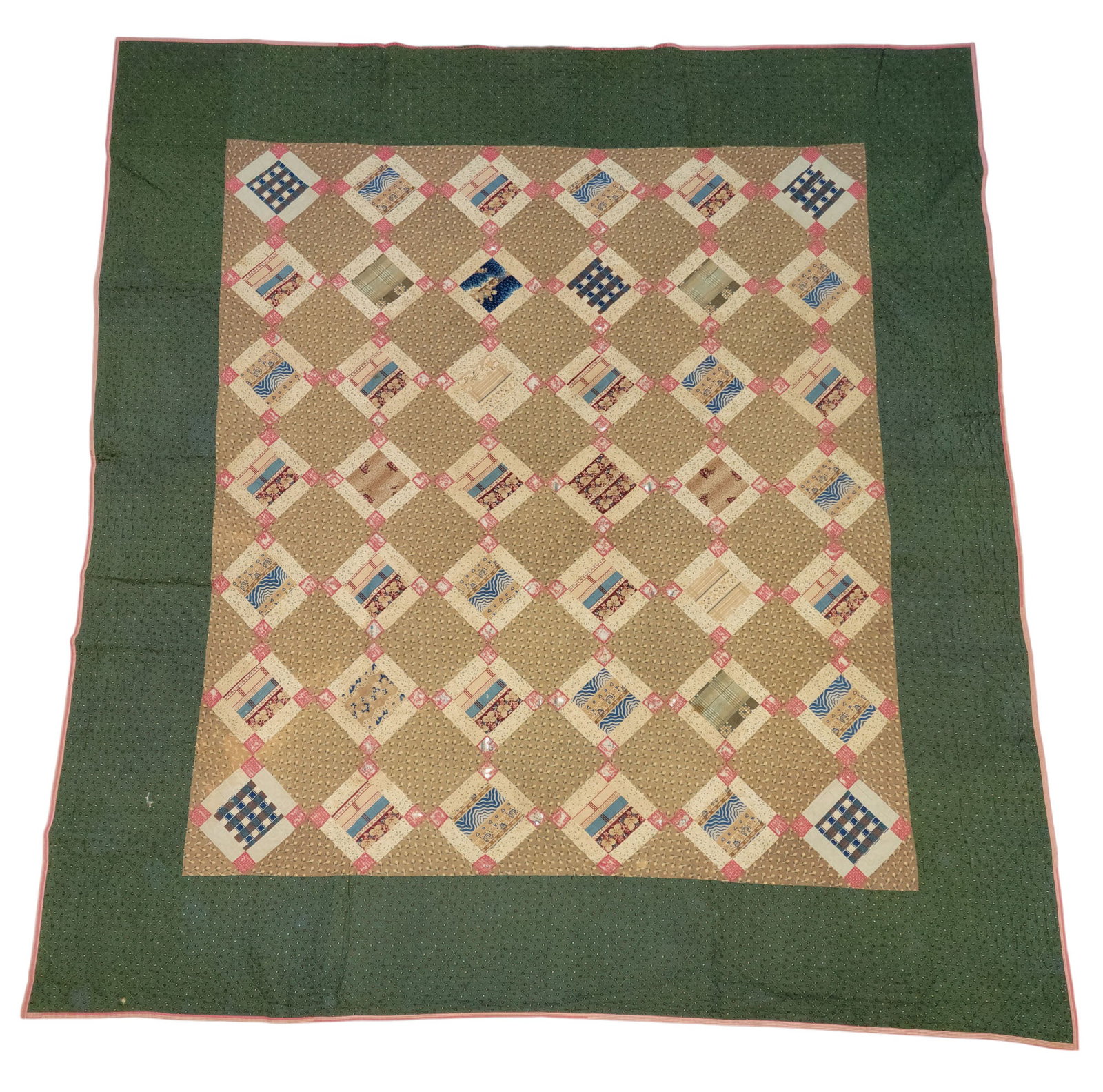 PIECED QUILT: American, 2nd half-19th century, cotton. Central field with 42 pieced diamonds, and with a border of printed green, and a dazzling printed backing. 92" by 83".