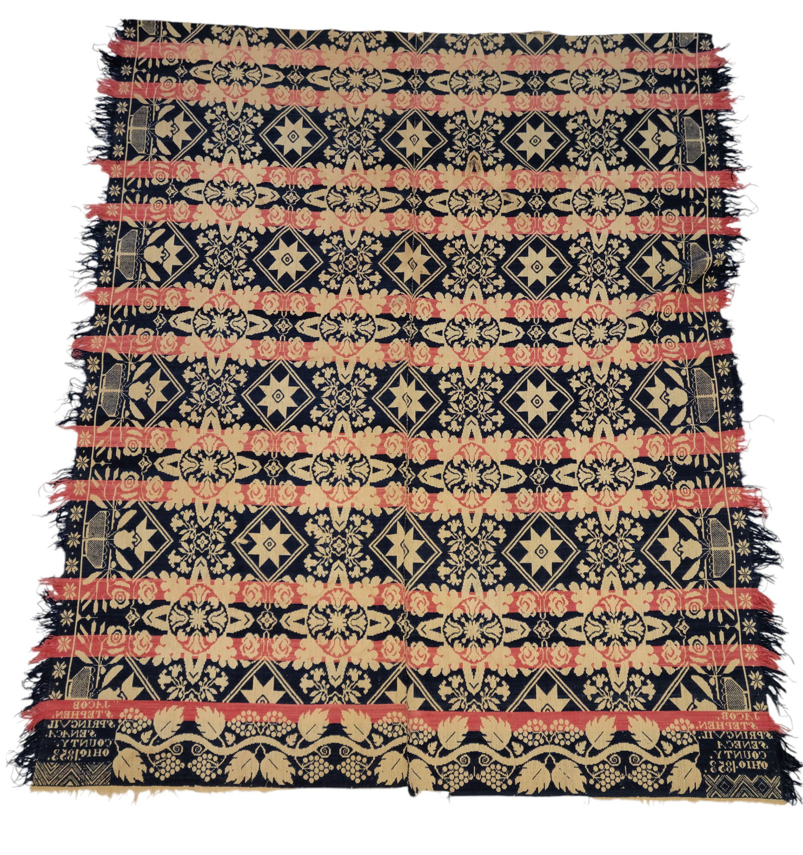 SENECA COUNTY, OHIO COVERLET: Jacob Stephen, Springville, 1853. Blue, red, and white, with stars and flowers, and borders with flower baskets and grapes. 90" by 76".