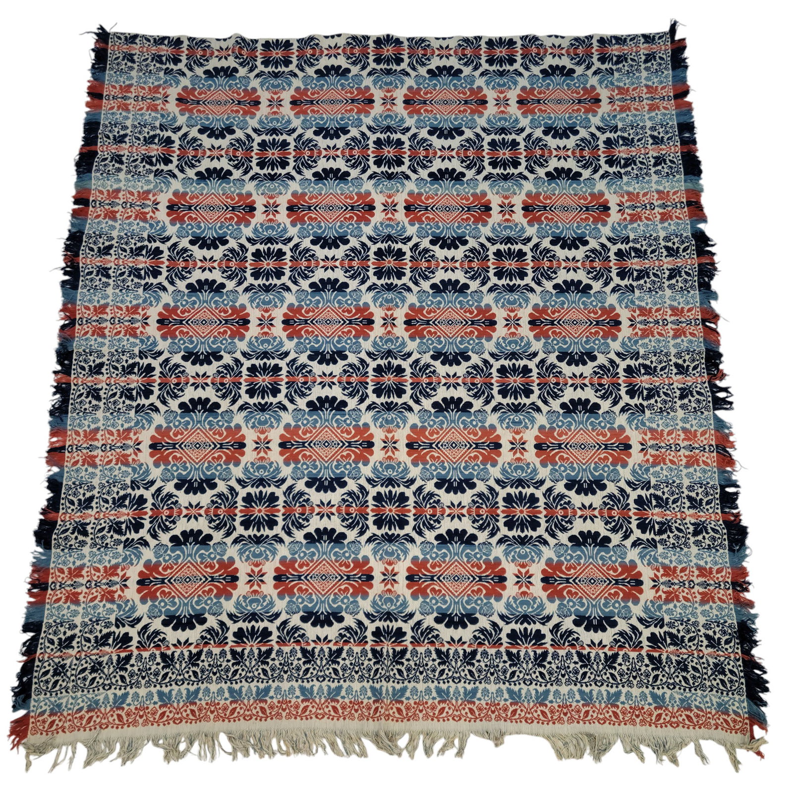 JACQUARD COVERLET: American, mid-19th century. Seamless, rust red, dark blue, and light blue centerfield of alternating rows of floral medallions, double borders of vining flowers, 92" by 79".Dr. Gunn acquired this cove
