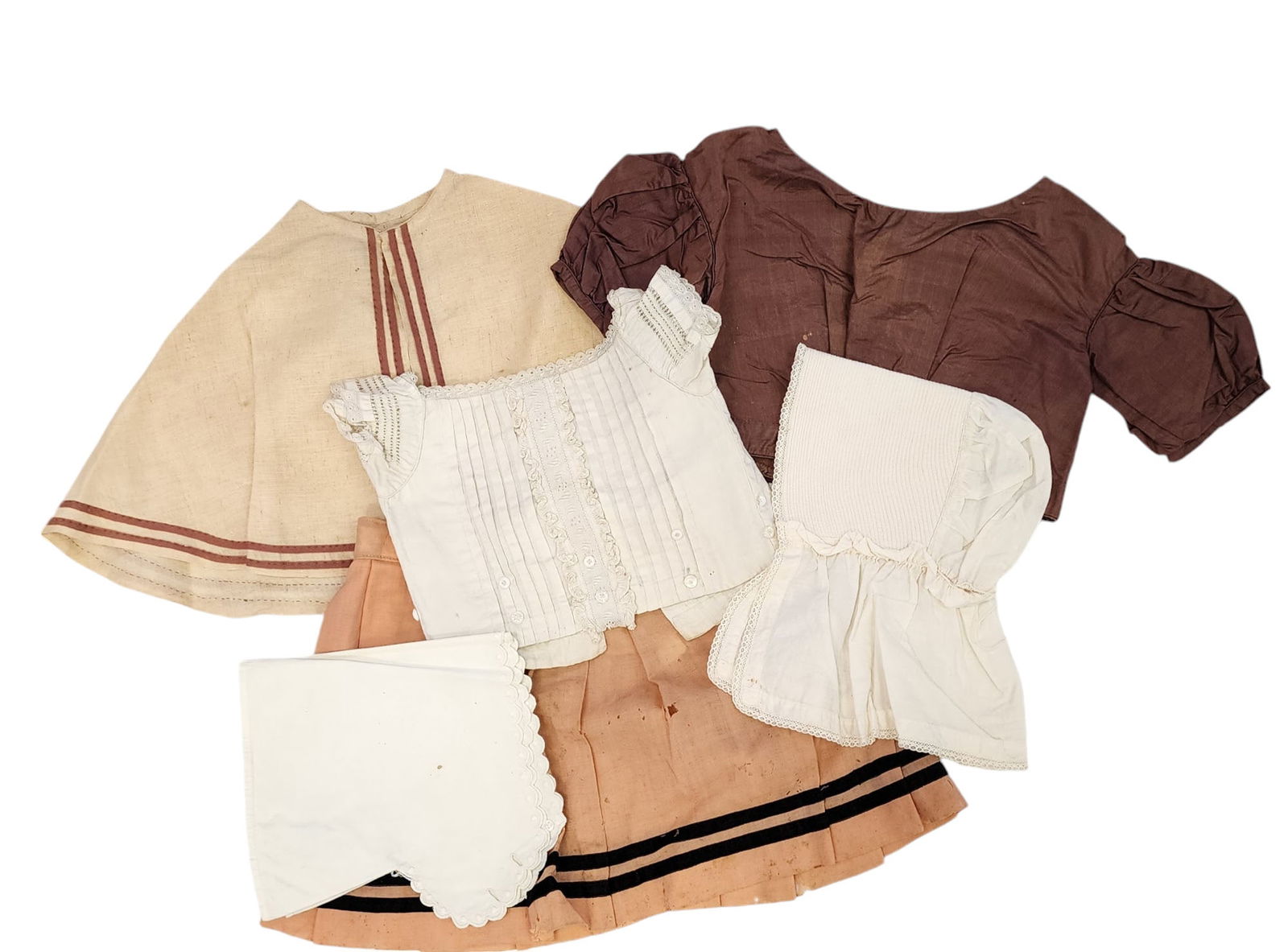 COLLECTION OF CHILDREN'S CLOTHING: 19th century. Six pieces, including two cotton chemise, a cap, a silk shirt, a wool skirt, and a cap.