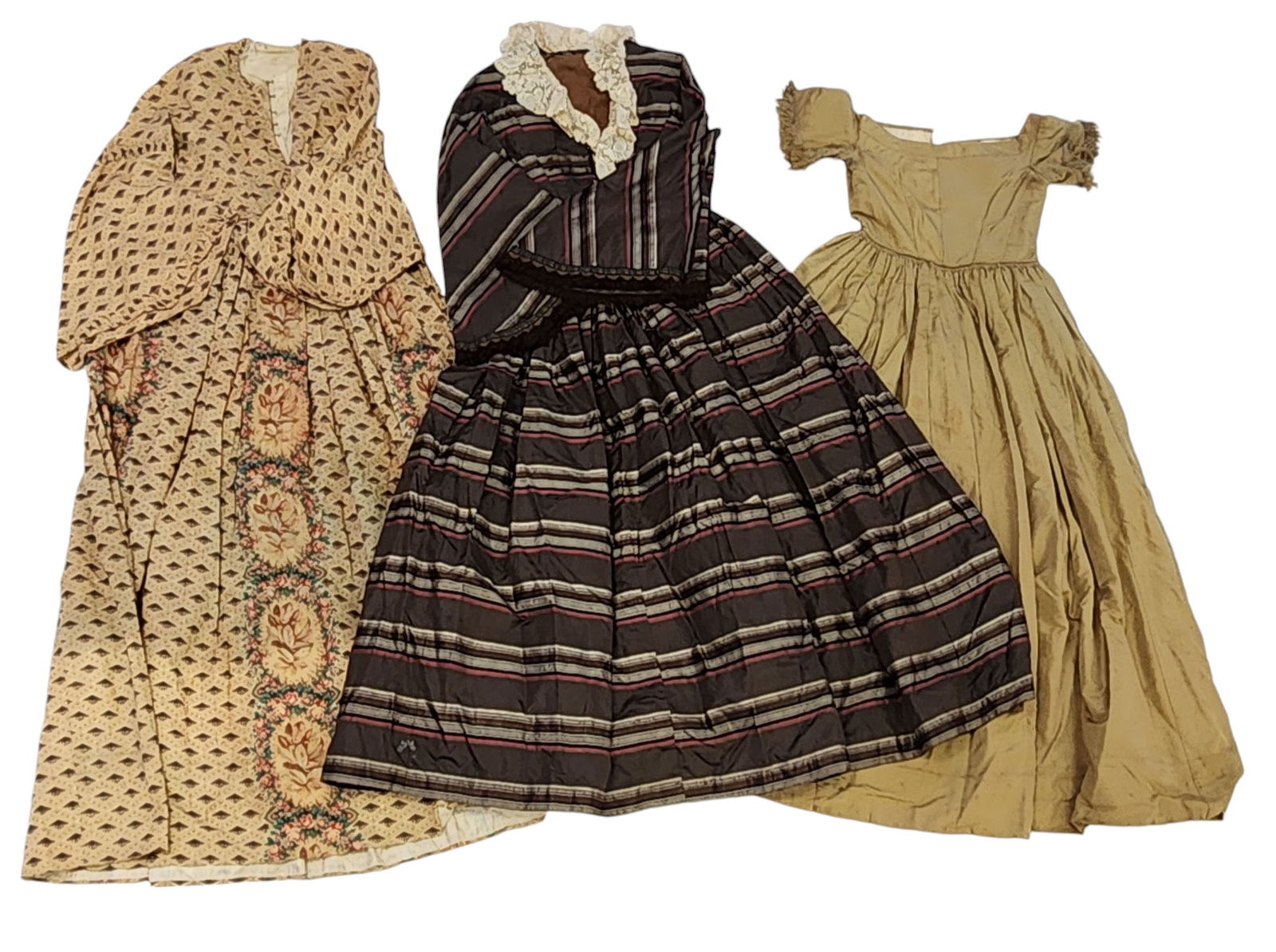 THREE LADY'S DRESSES: 1850s. Includes chartreuse silk with fringe on the sleeves and original stays, a brown and red striped silk with fringed sleeves, and a printed wool with small pocket and hooks and eyes.