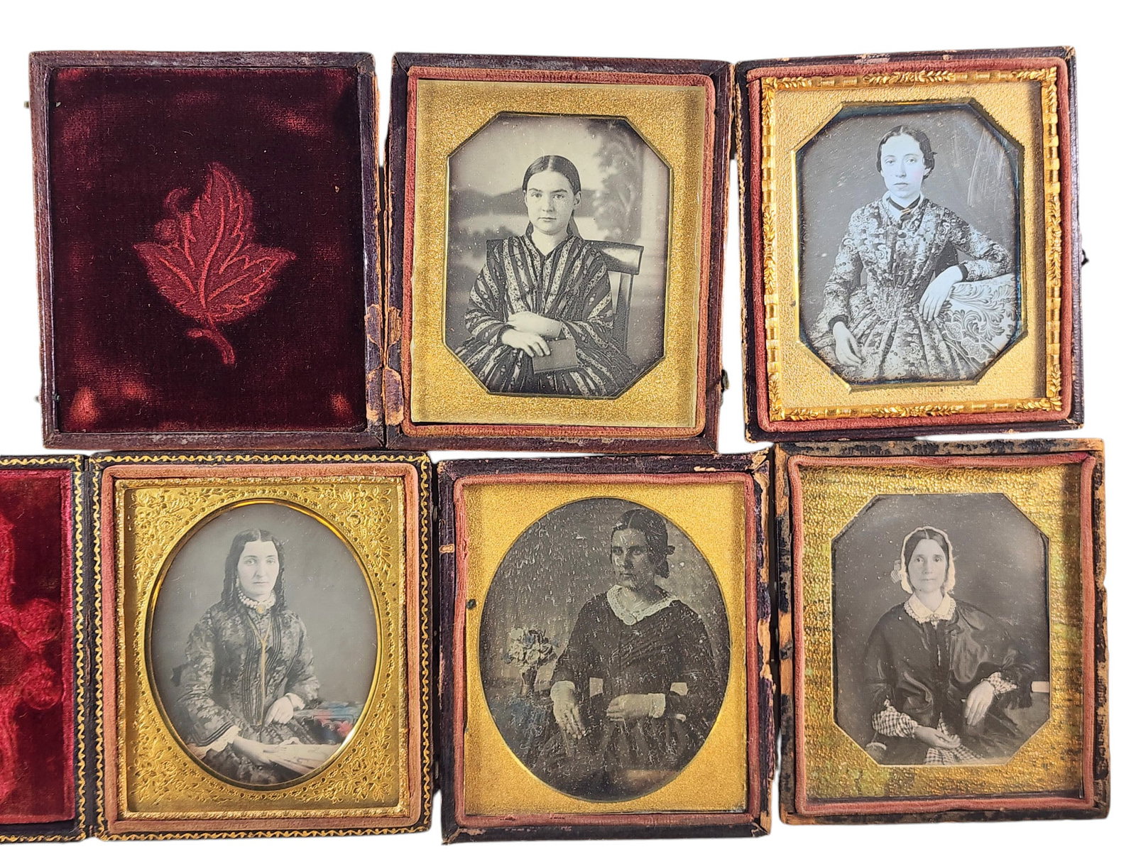 FIVE SIXTH PLATE AMBROTYPES: Mid-19th century. Three ladies and two appear to be teenage girls, all finely dressed. All are in pressed paper cases.