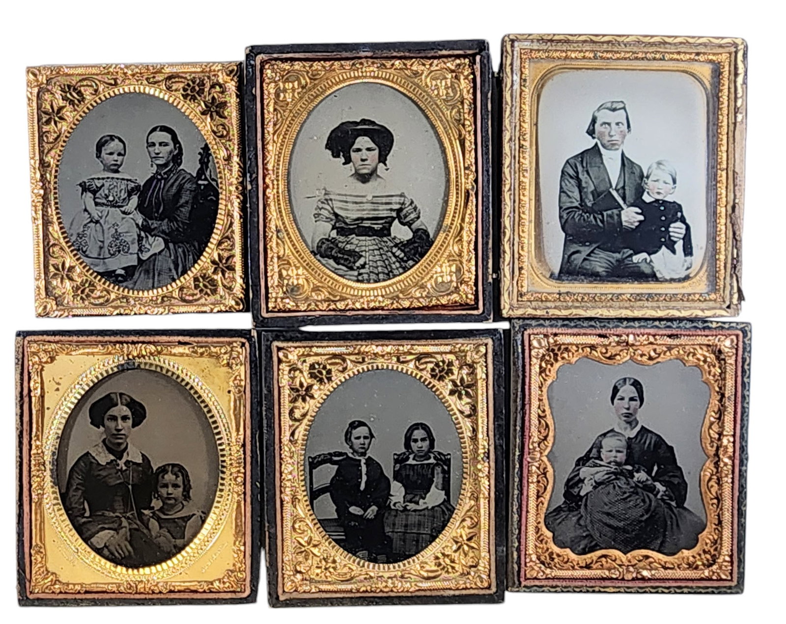 SIX SIXTH PLATE AMBROTYPES WITH CHILDREN: Mid-19th century. Includes four portraits of parents and children, and two of children only. The ambro of the mother and child sitting in a gothic chair has an 1860s R27 red revenue stamp on the back 