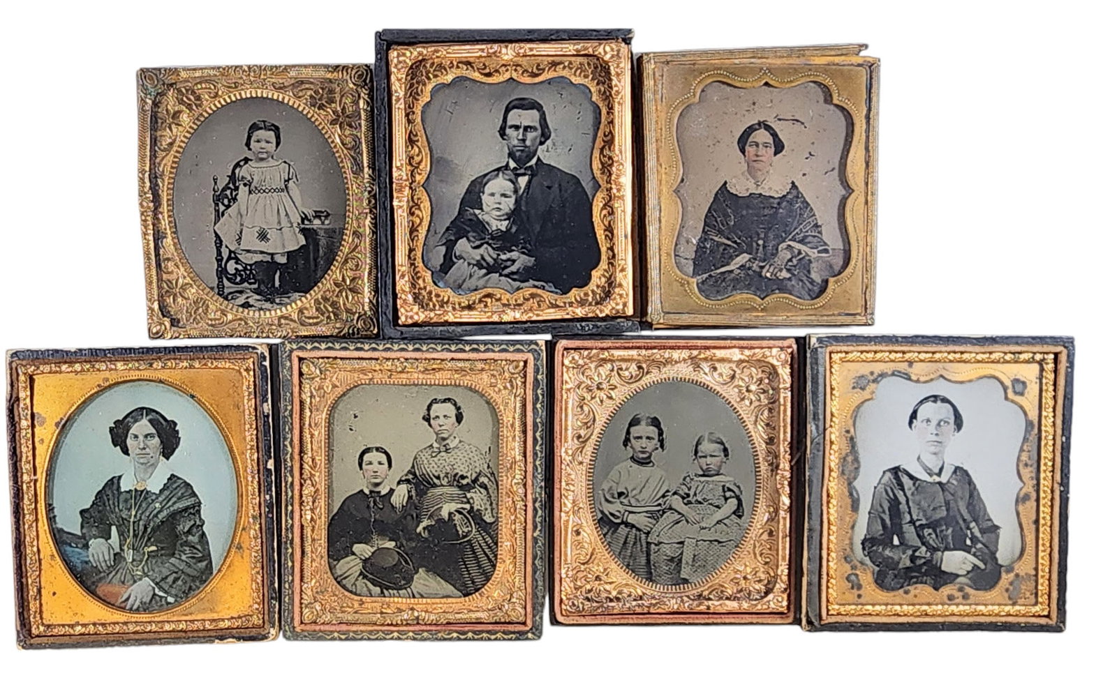 SEVEN SIXTH PLATE PHOTOGRAPHS: Mid-19th century. Includes one tintype of two children (in a thermoplastic case), and six ambrotypes including some children (some in pressed leather cases).