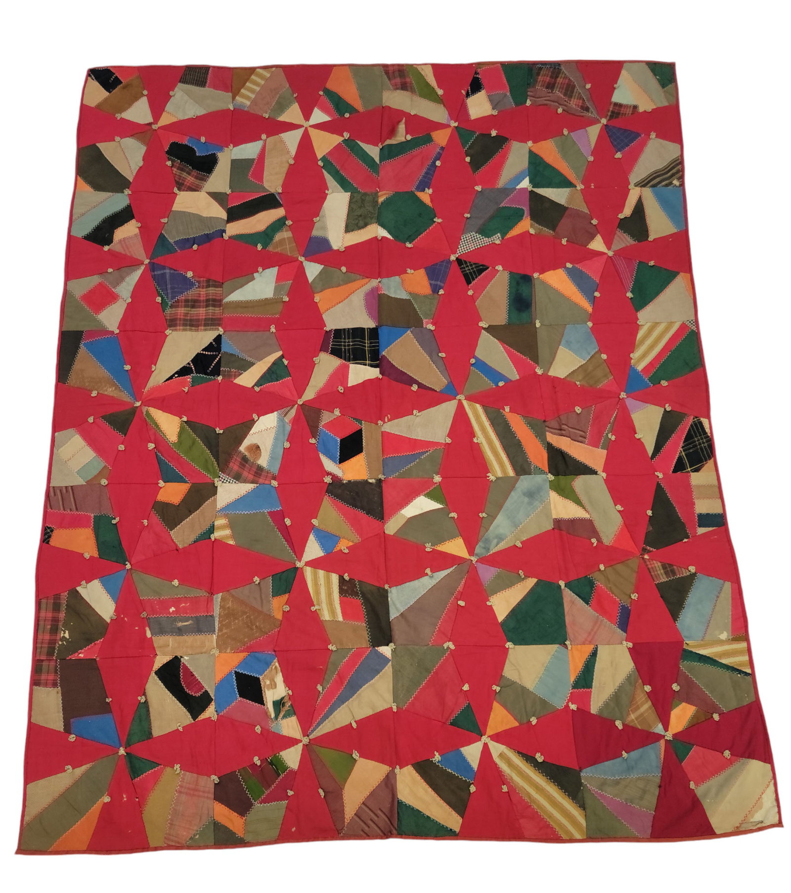 TIED CRAZY QUILT: American, late 19th-early 20th century, various fabrics. Abstract design with dominant red stars. 83" by 63".