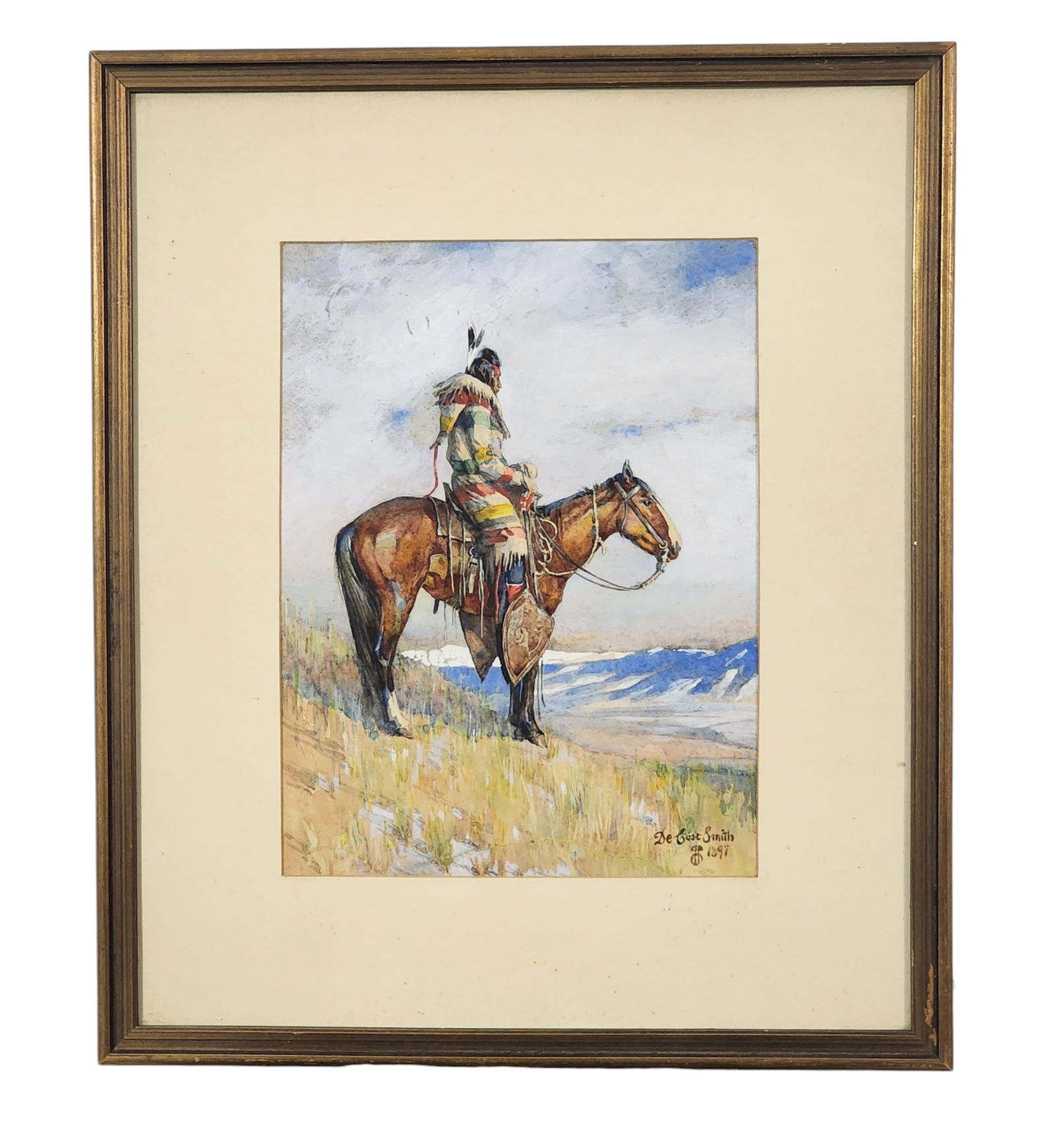 DE COST SMITH (NEW YORK, 1864-1939): PORTRAIT OF A NATIVE AMERICAN: Watercolor and gouache on paper, signed and dated 1897 lower right. Dramatic view of a mounted Native American, looking across the high plains. Matted and framed. 12" high, 9" wide (sight); 19.25" hig
