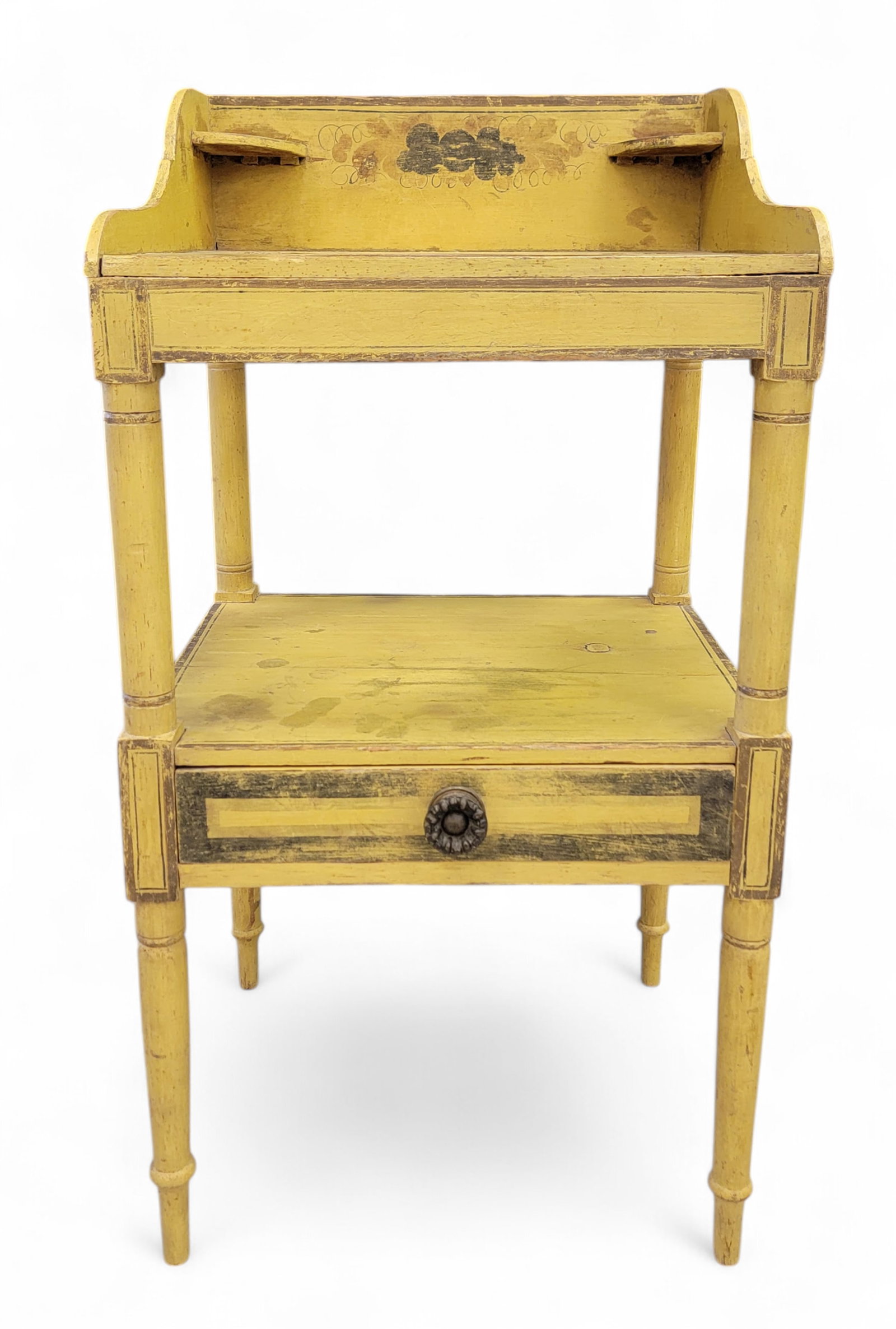 PAINT-DECORATED WASHSTAND: New England, 1815-1830, pine. Basin cutout and a lower drawer, and with its original floral decoration on a bright yellow ground. 35.25" high, 18.25" wide, 15.5" deep. Provenance: From the Lifetime Co